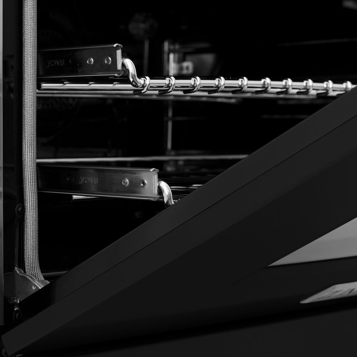 Close-up of oven interior racks with metal rails and hook-style support