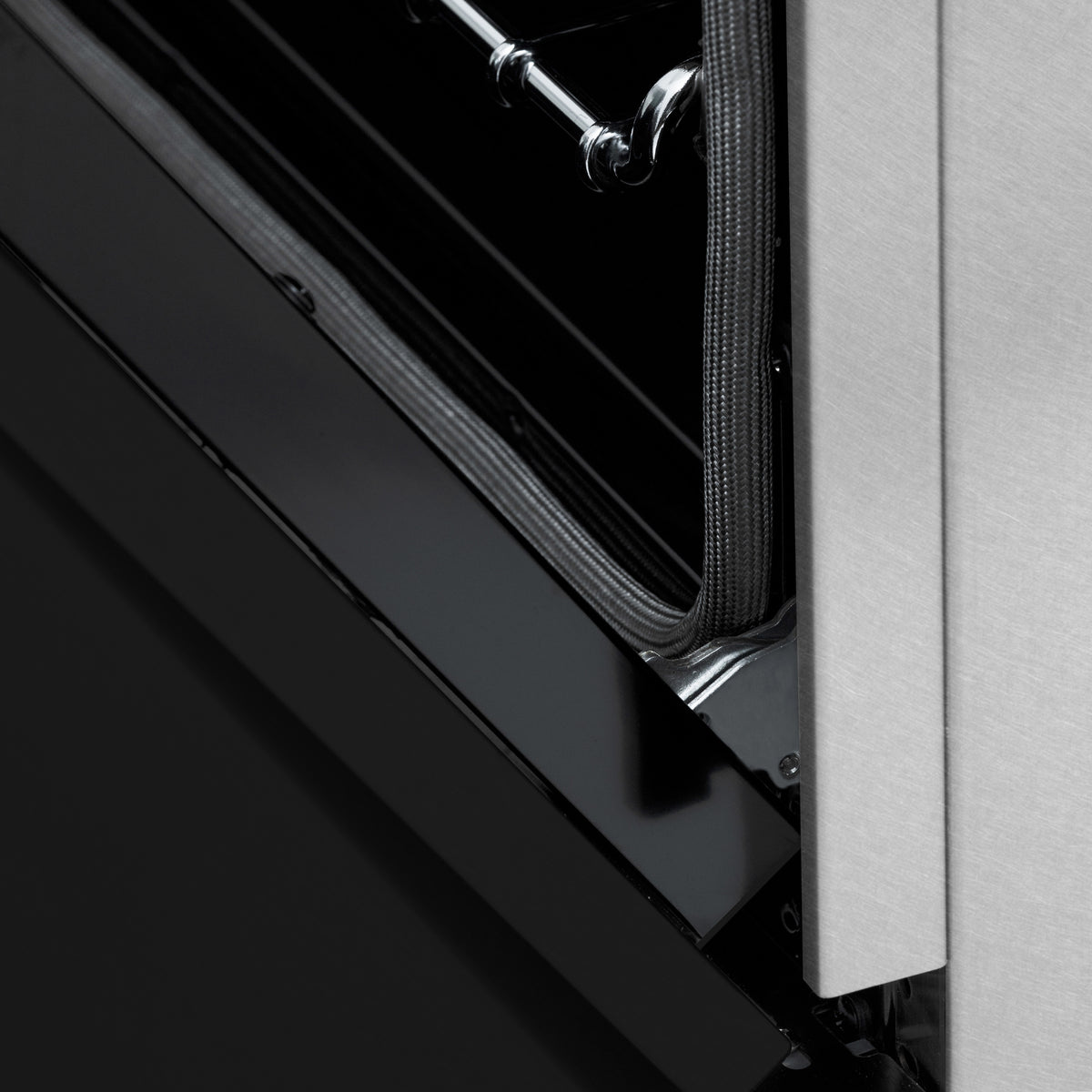 Close-up of oven door seal and hinge area on the dual fuel range