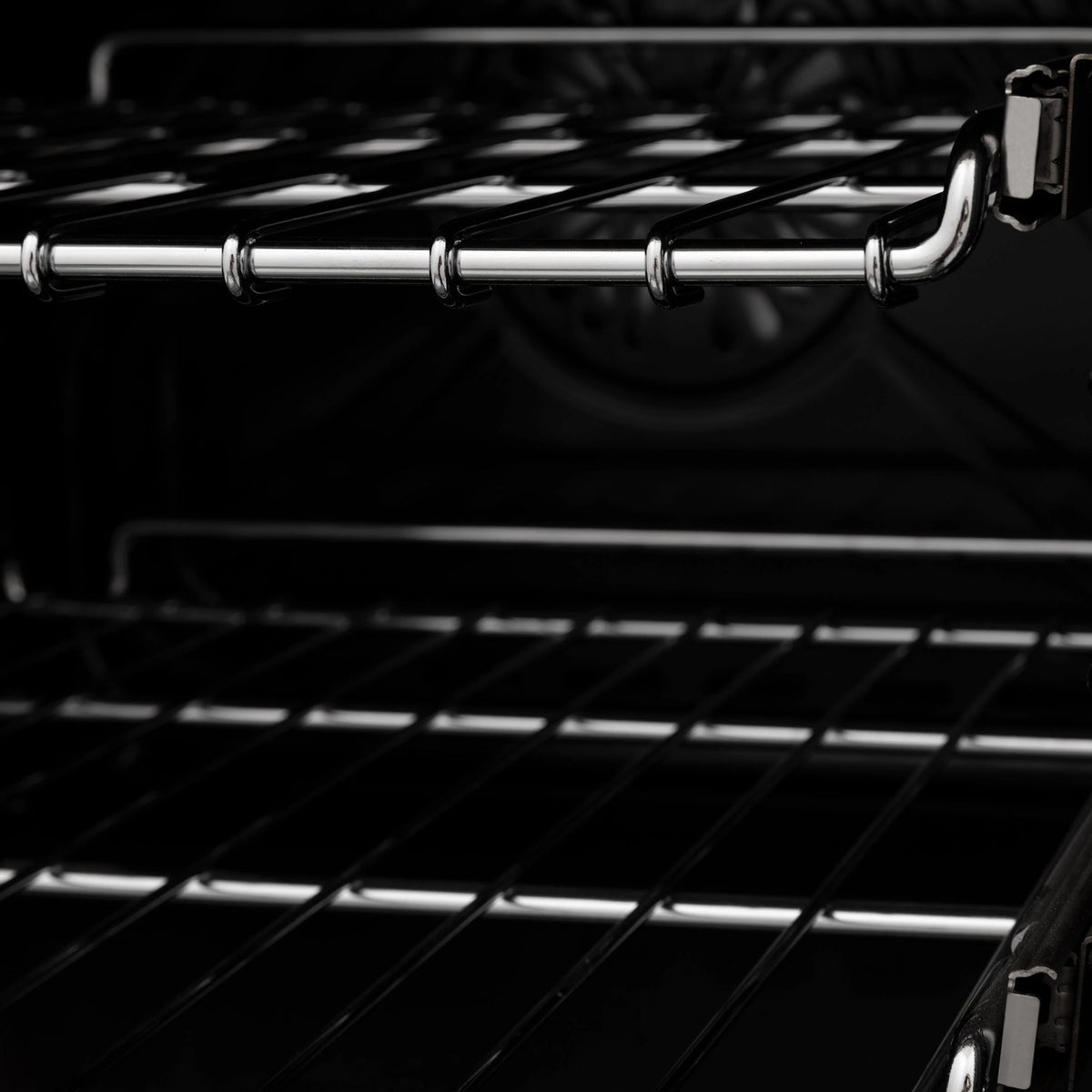 Electric oven rack with black rails and pull handle inside the range