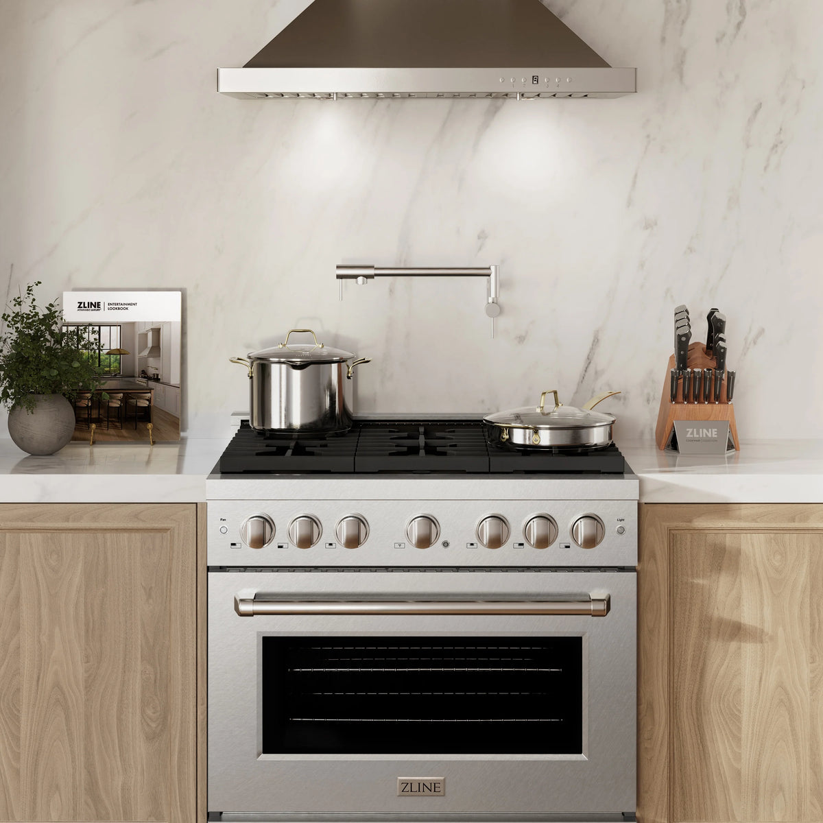 Stainless steel freestanding gas range under a wall-mounted vent hood