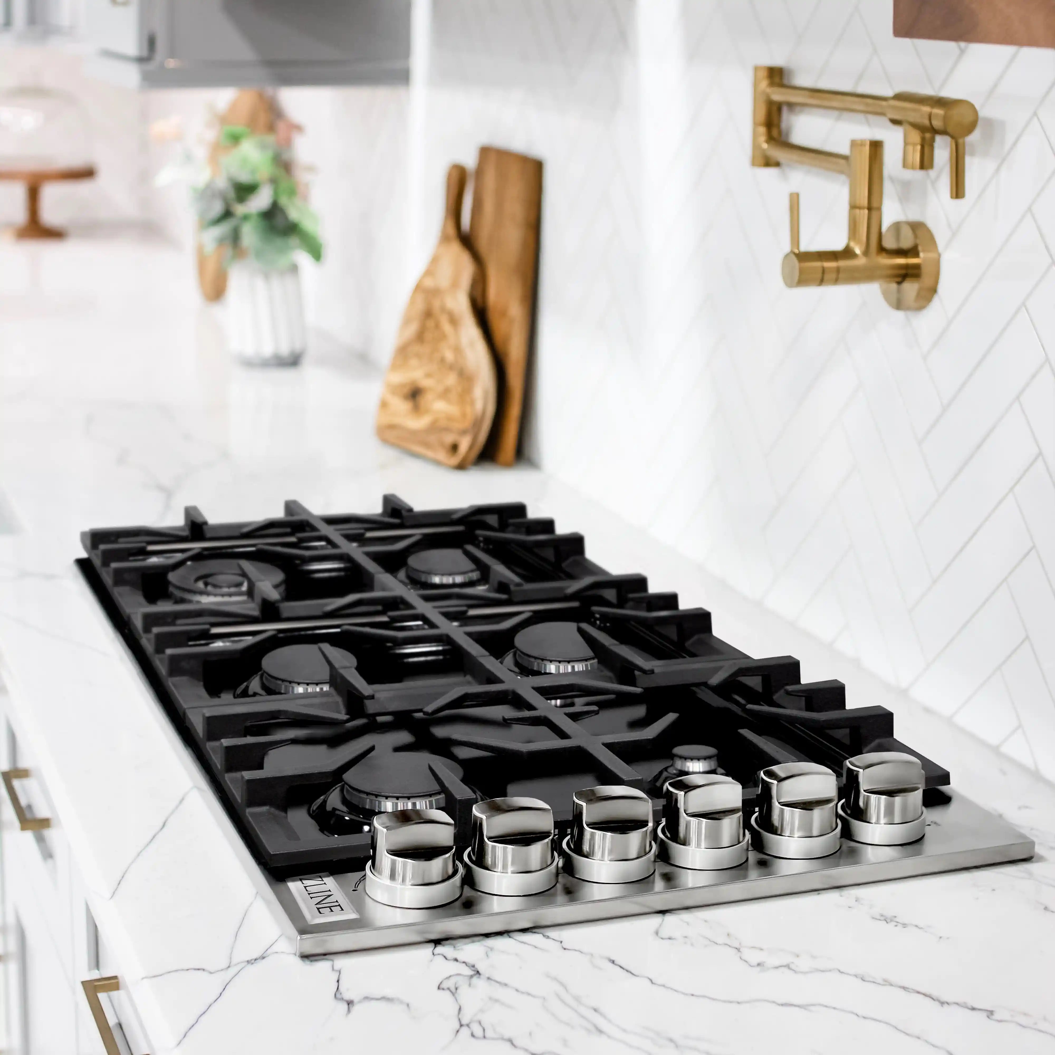Black gas cooktop with six burners on black porcelain top and matching grates