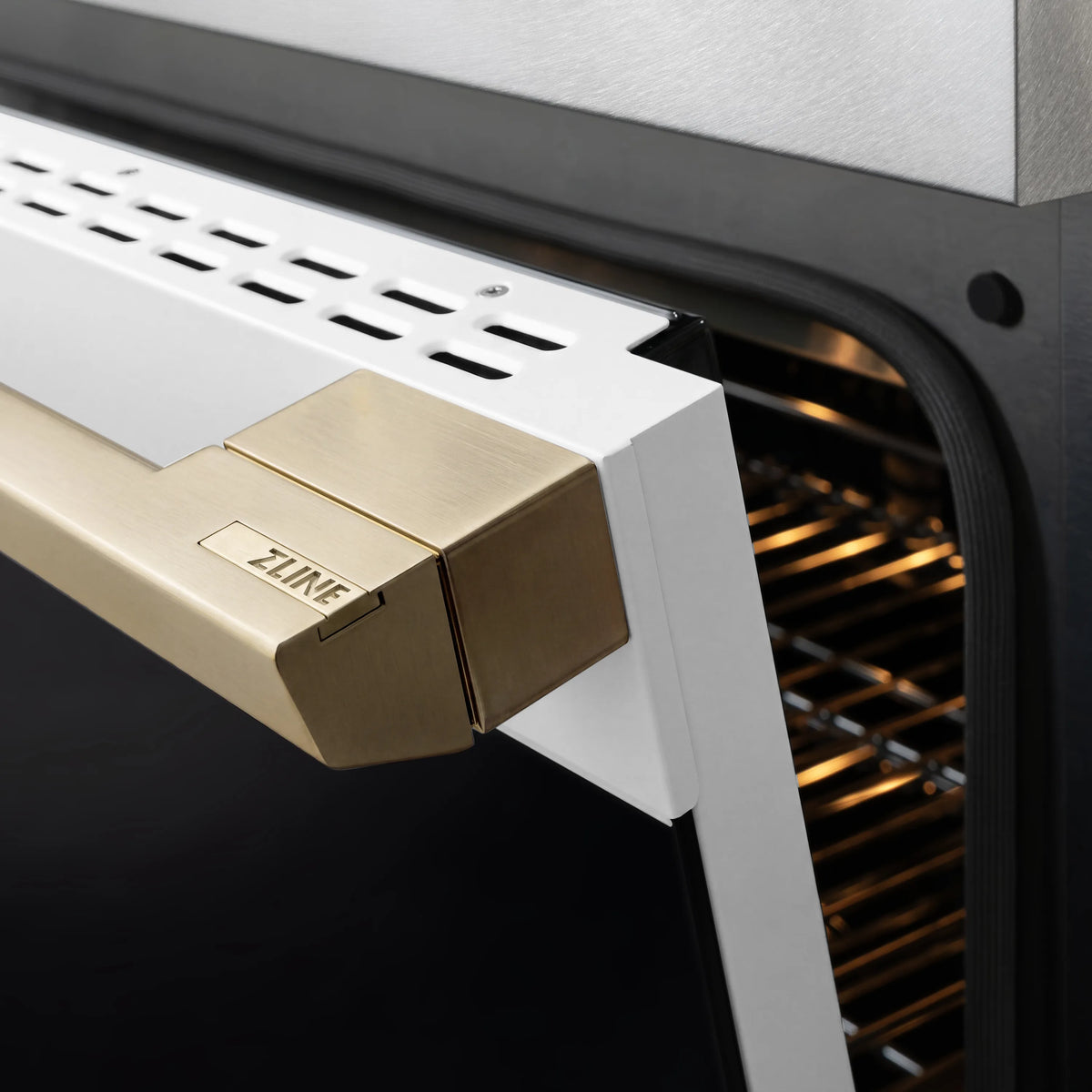 ZLINE gas range igniter module inside oven with lighted heating area