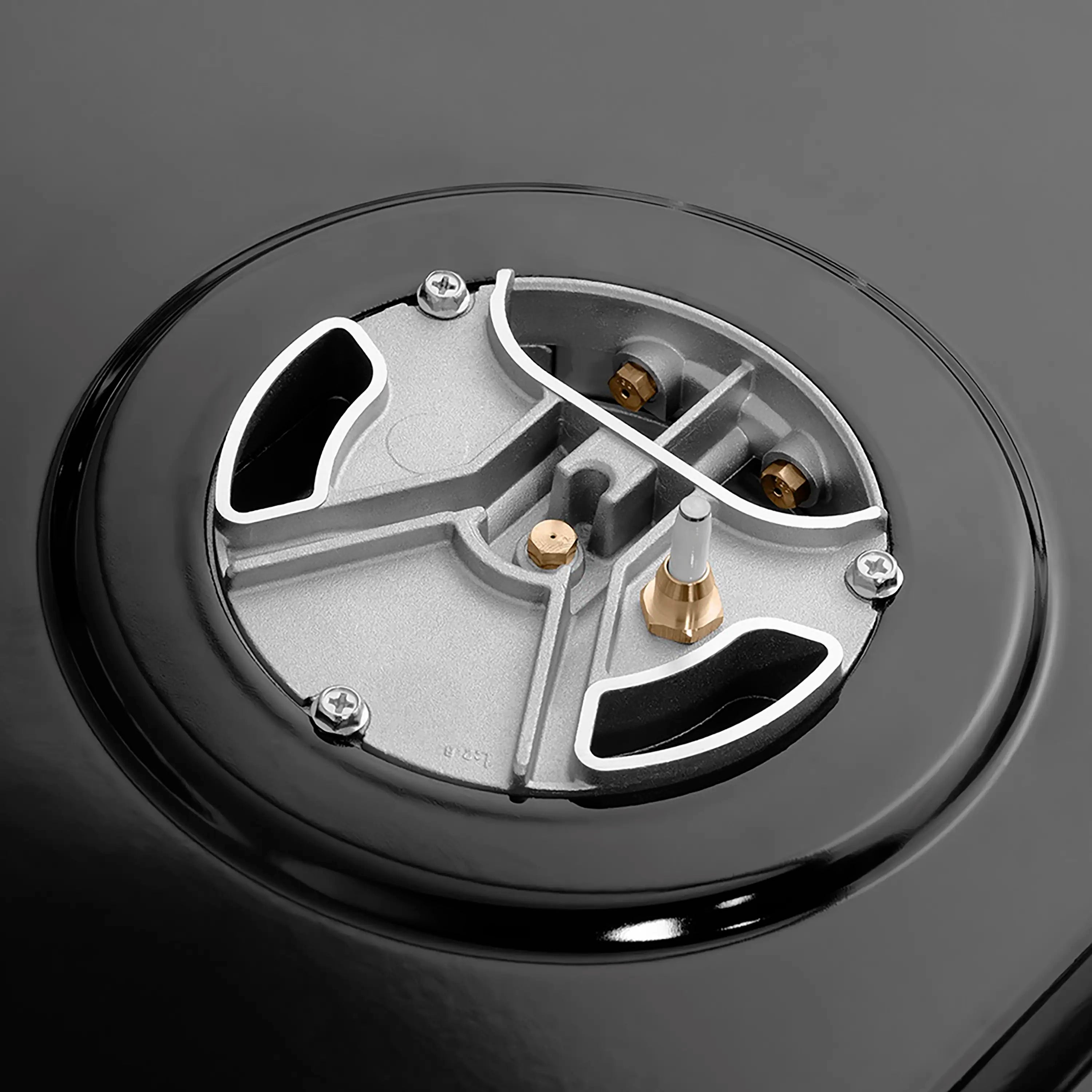 ZLINE gas range burner cap close-up with brass gas ports and black enamel base