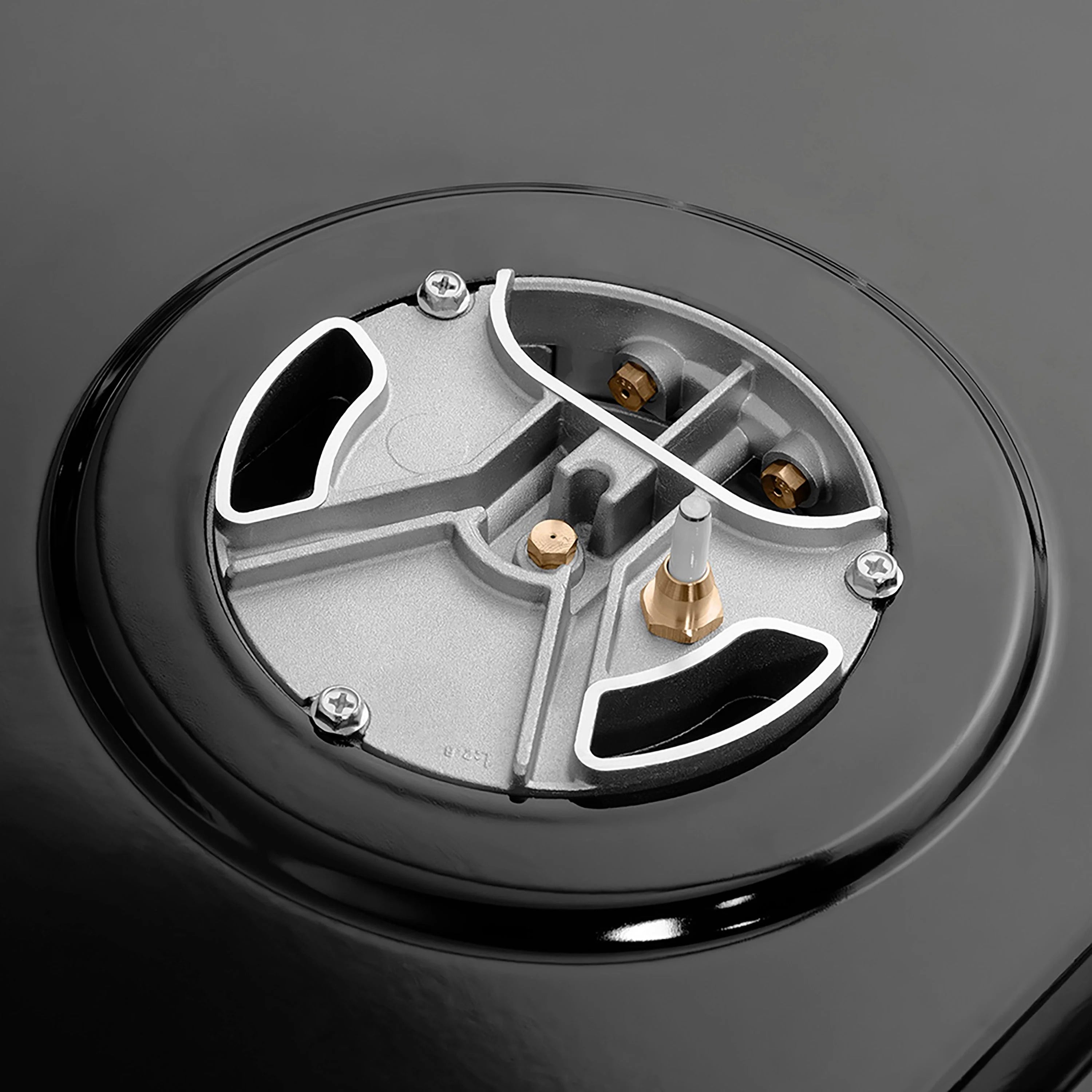 Gas burner cap detail with brass fittings inside round burner base