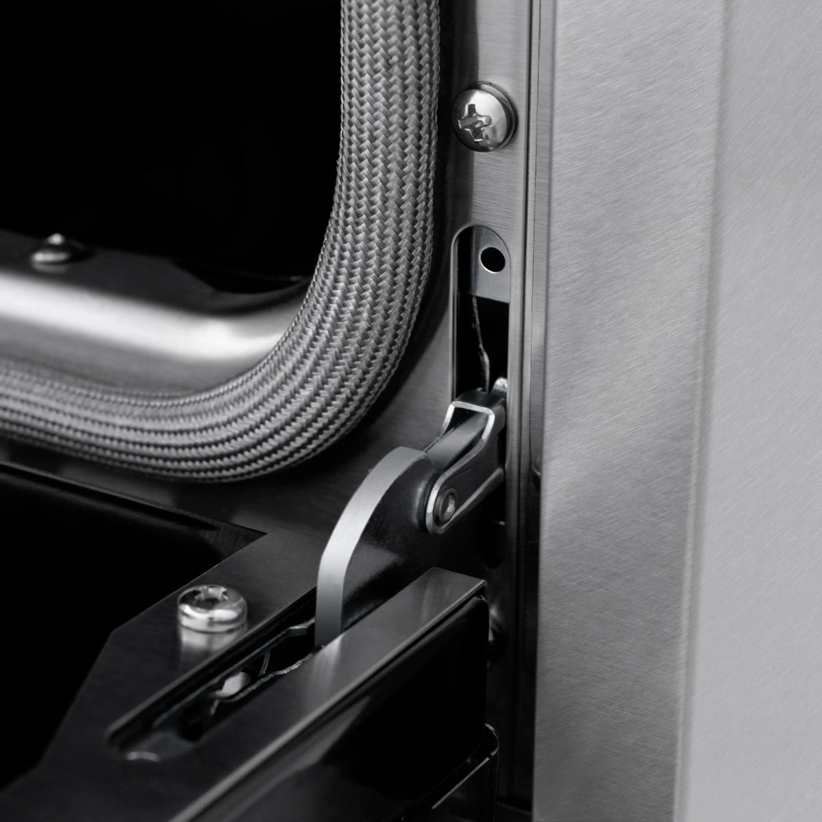 Induction range side panel with stainless hardware and oven door latch detail