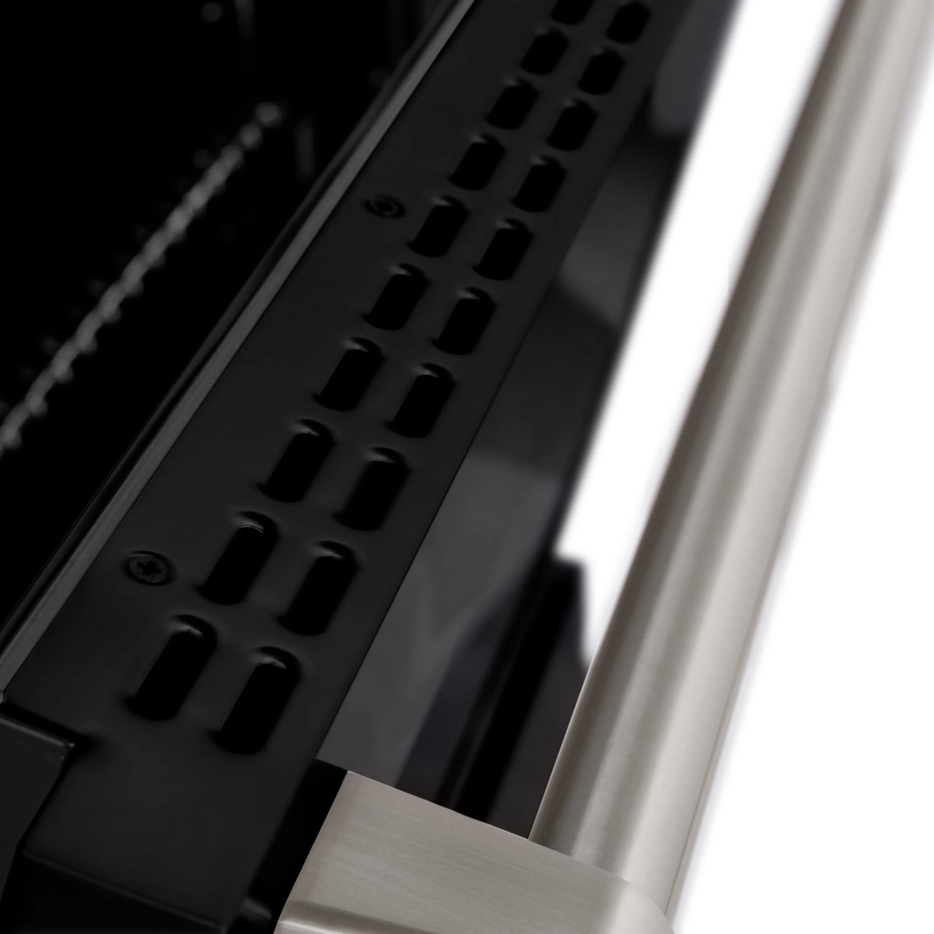 Black gas cooktop with cast grates and burner slots on stainless dual fuel range