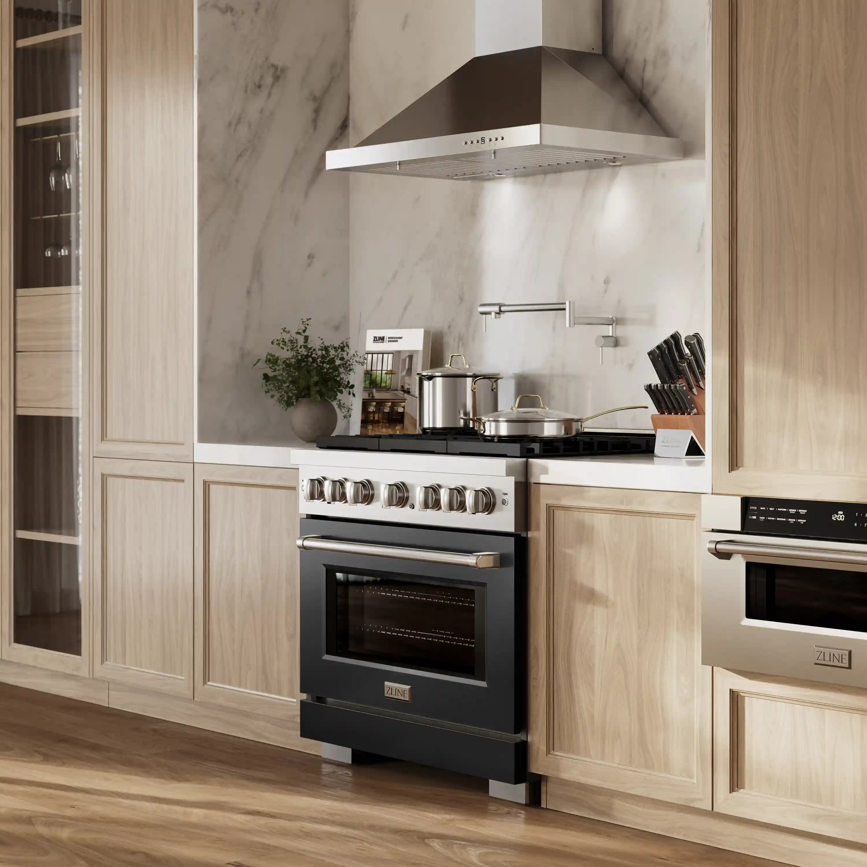 Stainless and black dual fuel range in kitchen with overhead hood