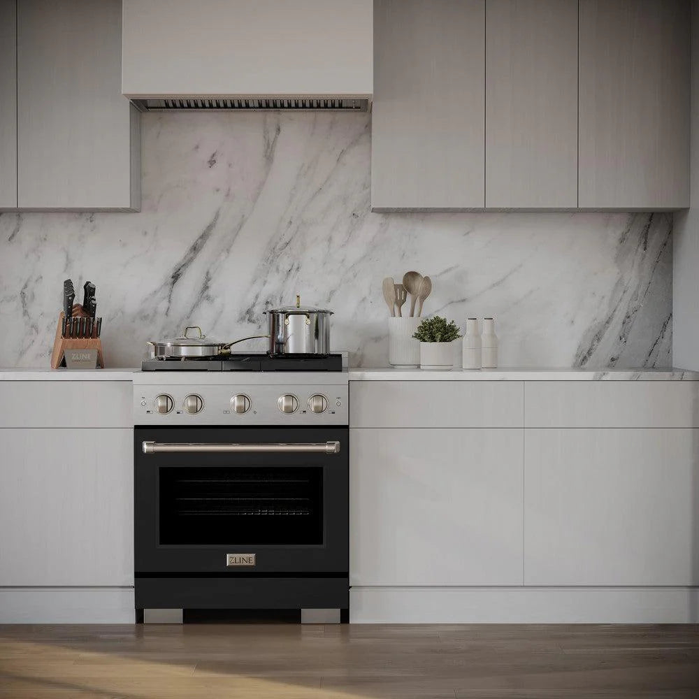 Stainless steel gas range with black oven door and four burners in modern kitchen