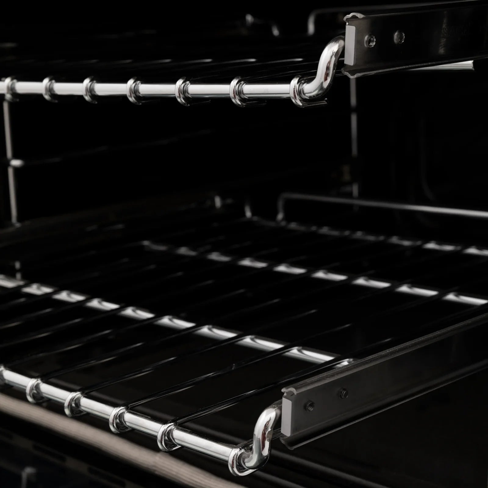 Oven interior with chrome racks and black cooktop grates, close-up