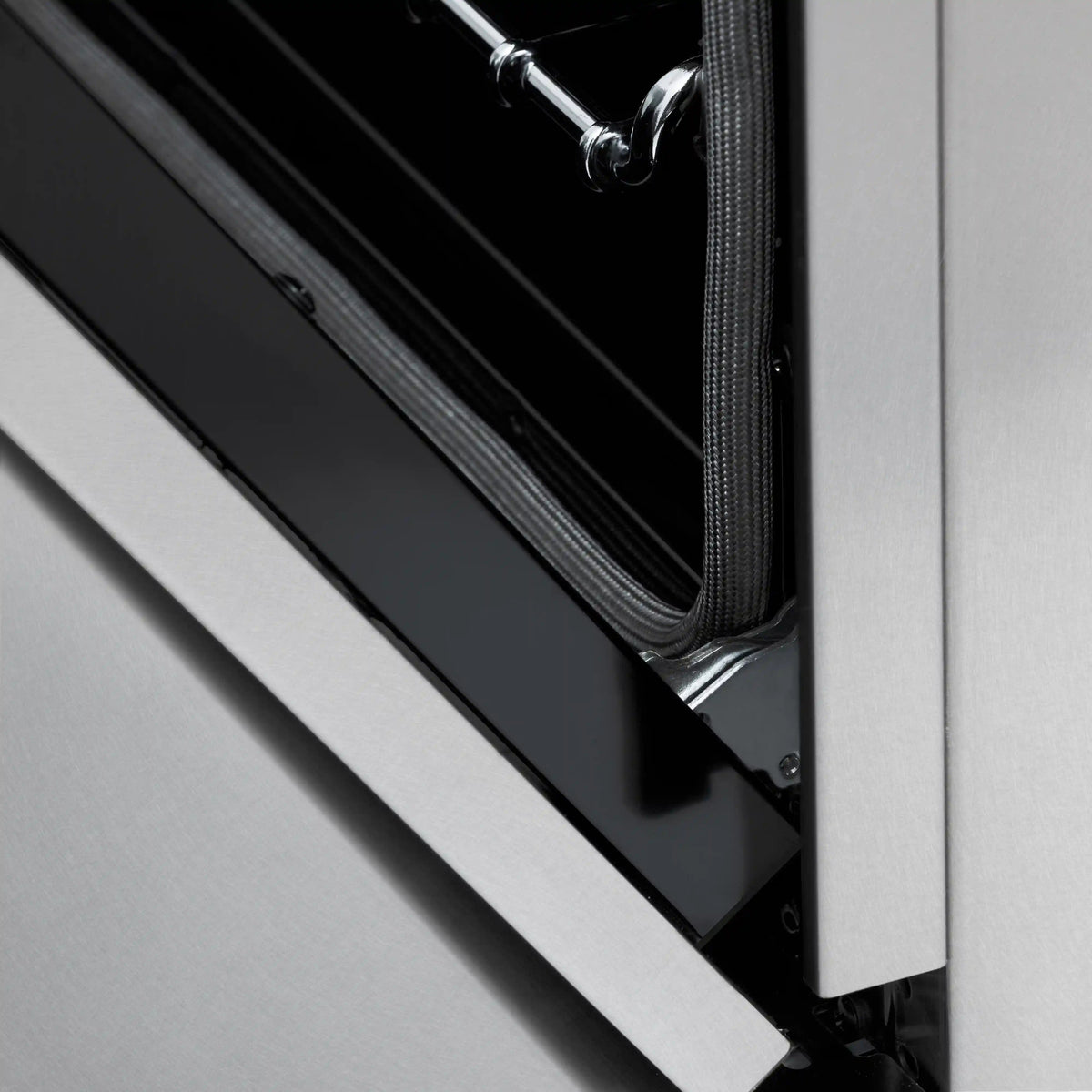 Gas range oven door opening with satin stainless frame and black interior panel