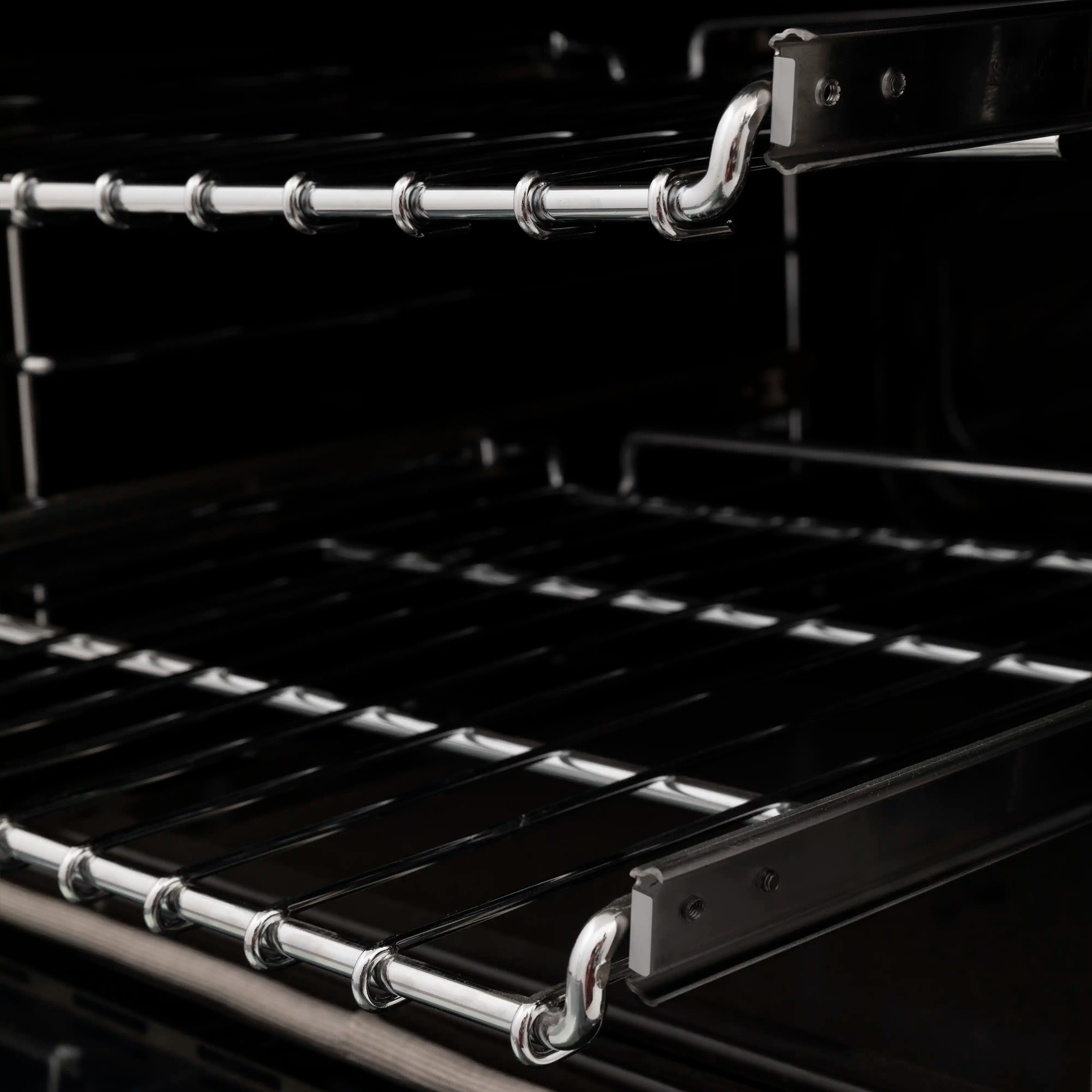 Electric oven rack rails and wire shelves in a black oven interior