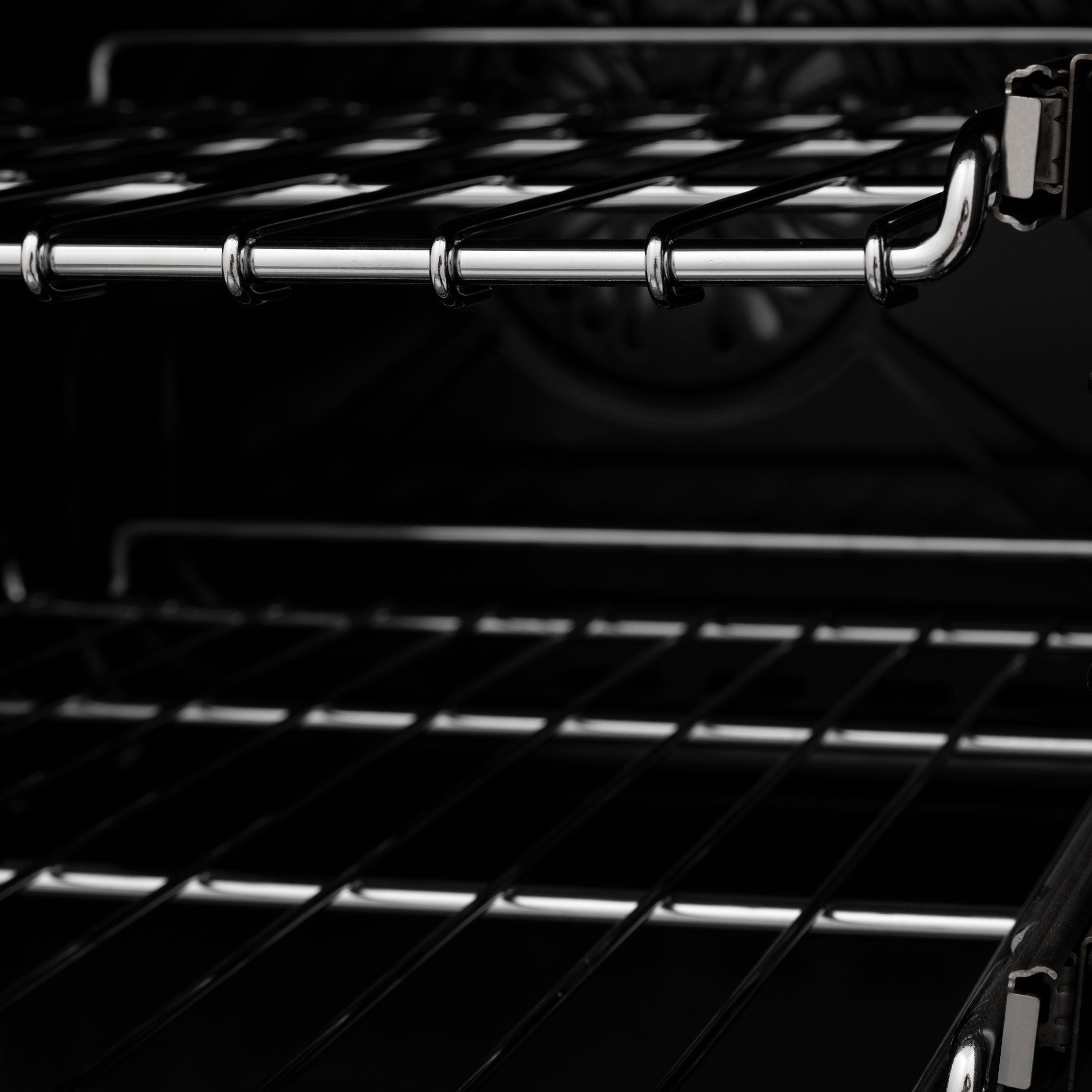 Dual fuel range grates with shiny metal rod burners and black enamel cooktop