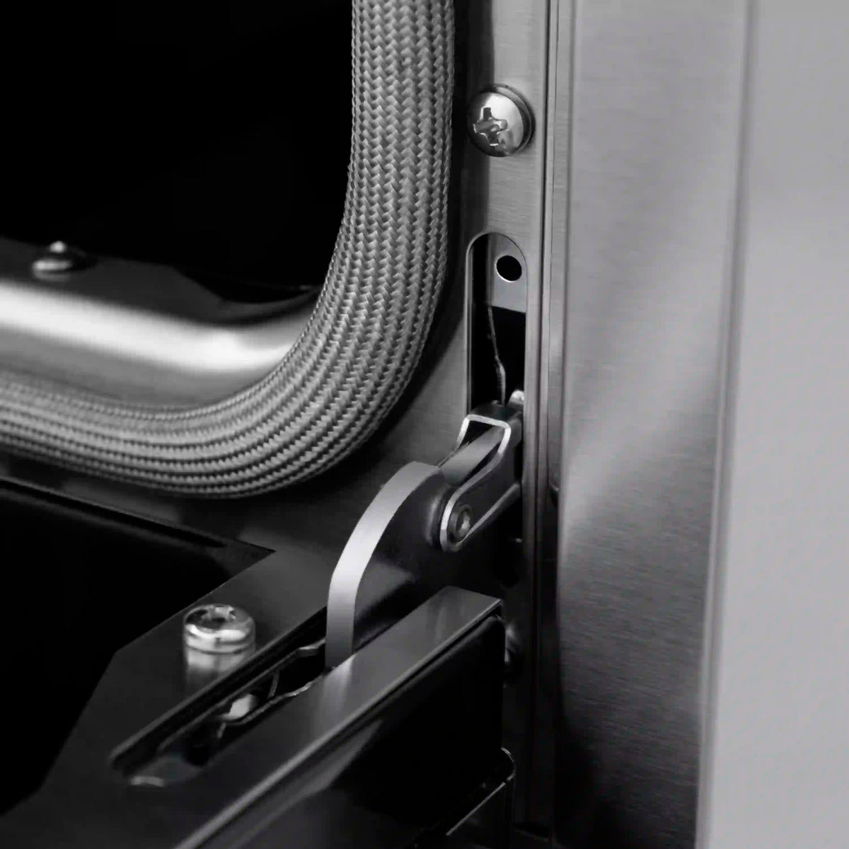 Side connection area on stainless dual fuel range with flexible gas line