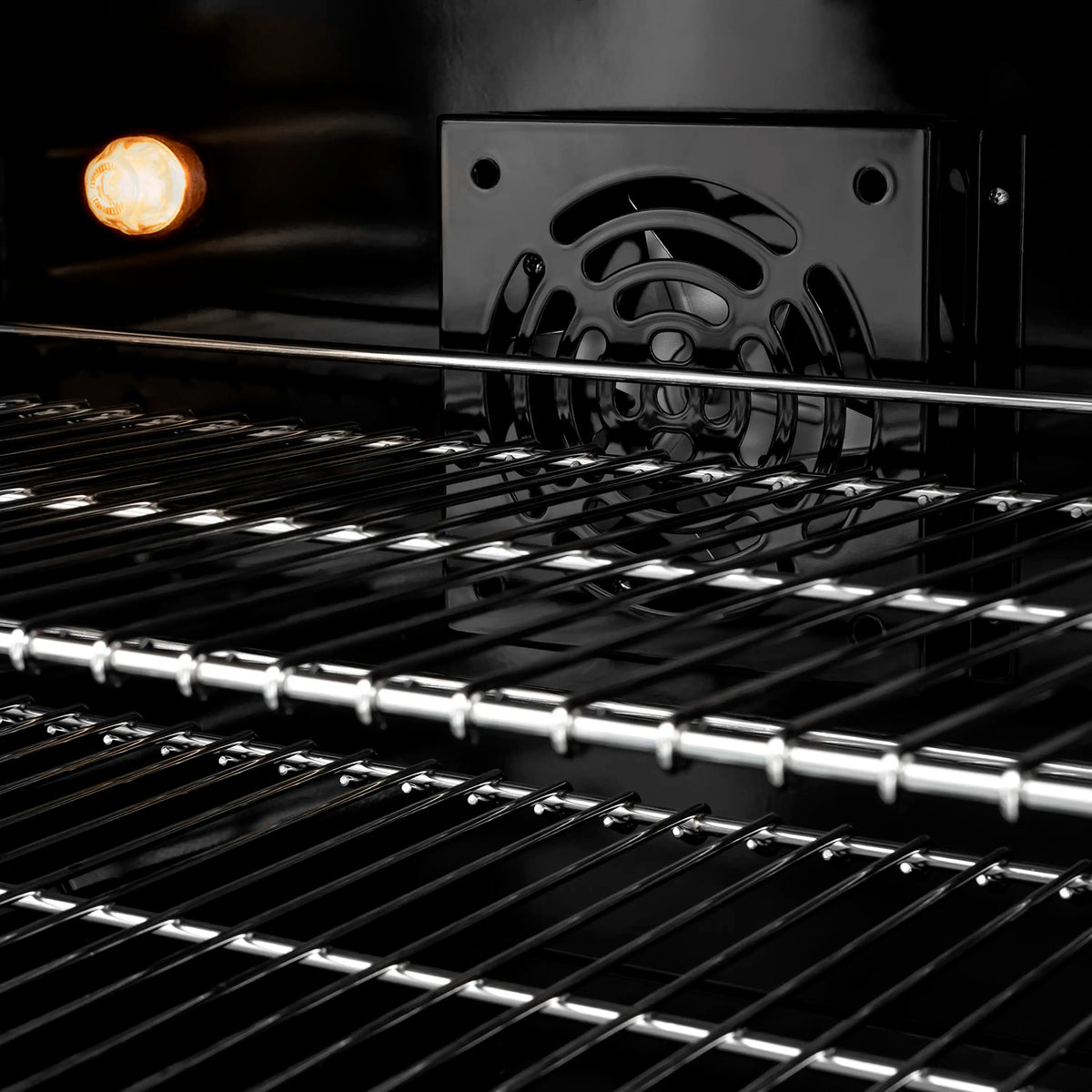 Dual fuel range oven with chrome racks and glowing broil burner