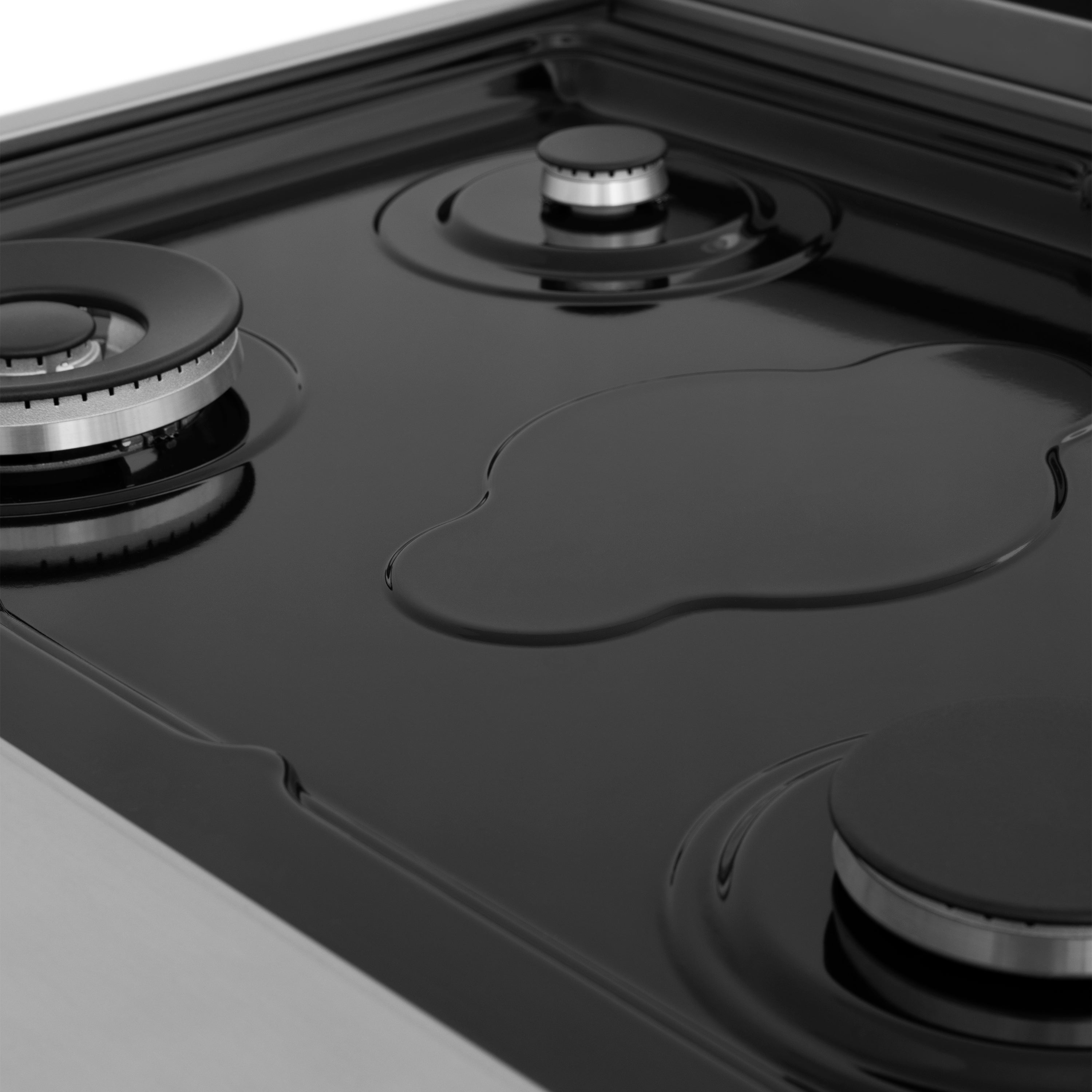 Stainless steel cooktop surface with circular burner rings and control details