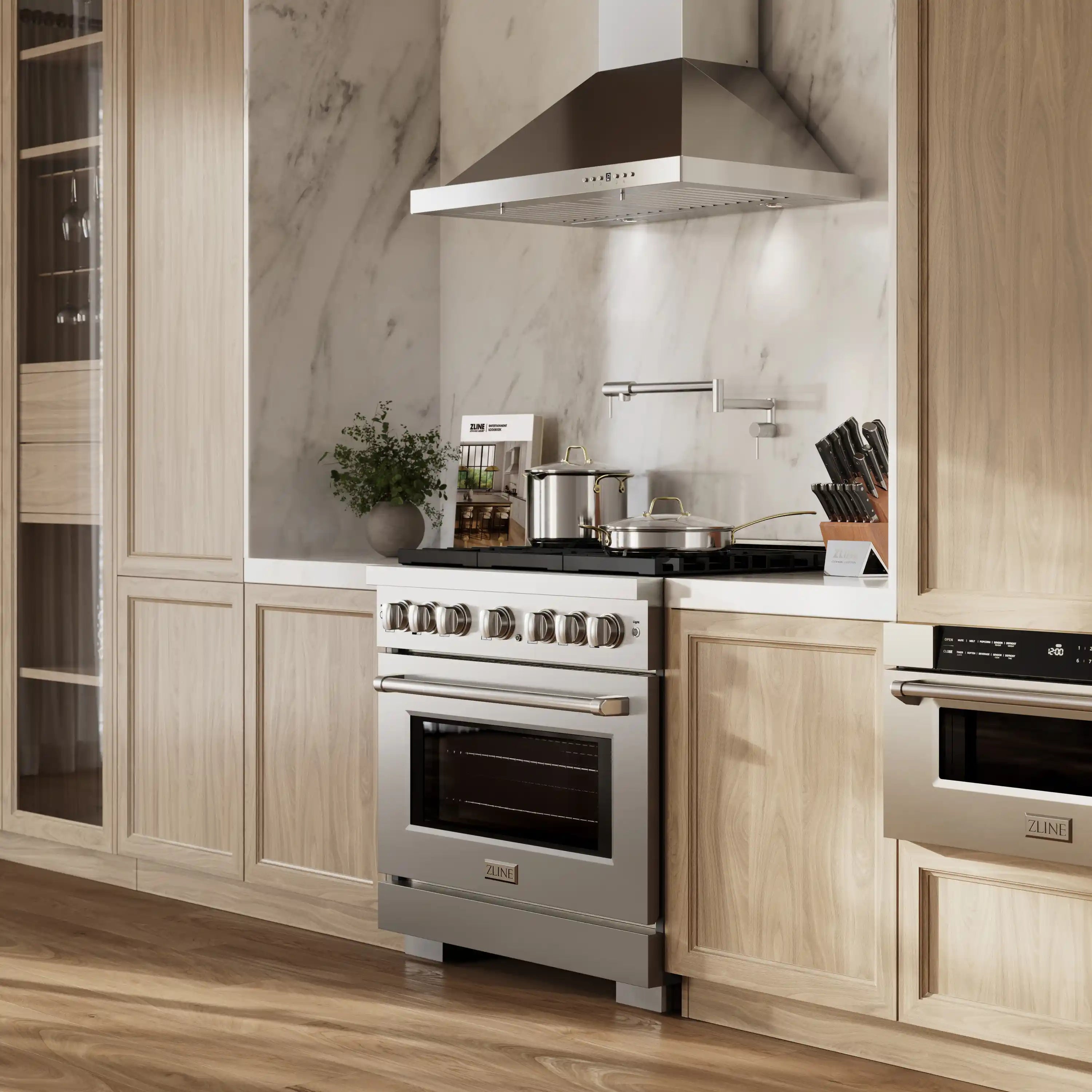Stainless steel dual-fuel range in a kitchen with black cooktop grates