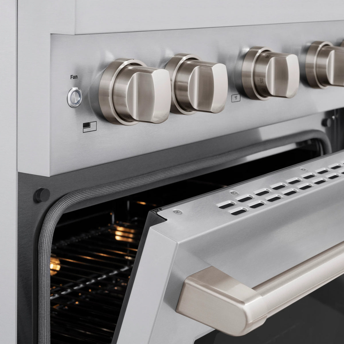 Stainless steel gas range close-up of fan control knob and vent area below