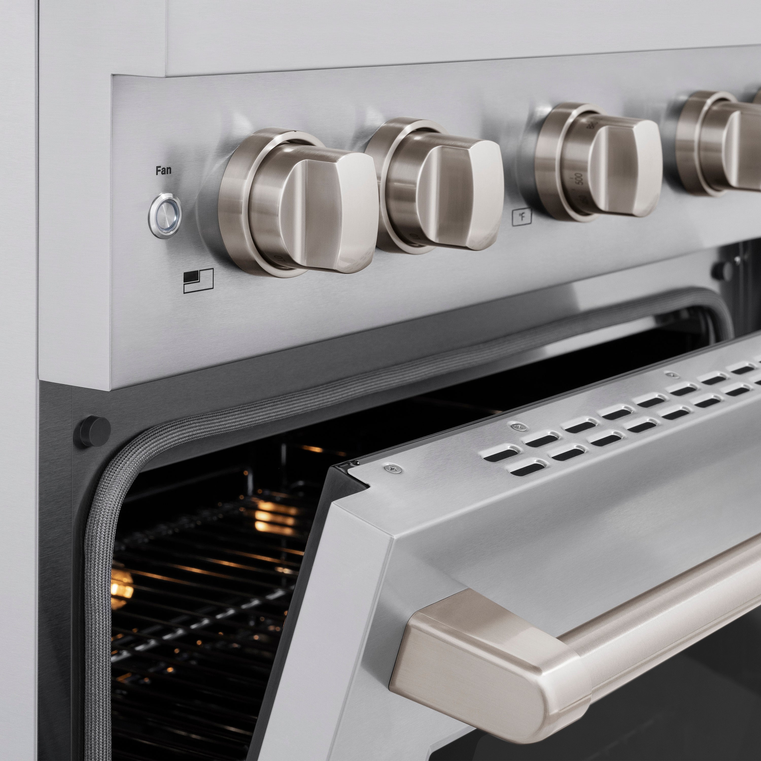 Stainless steel oven control knobs and oven handle with front panel detail