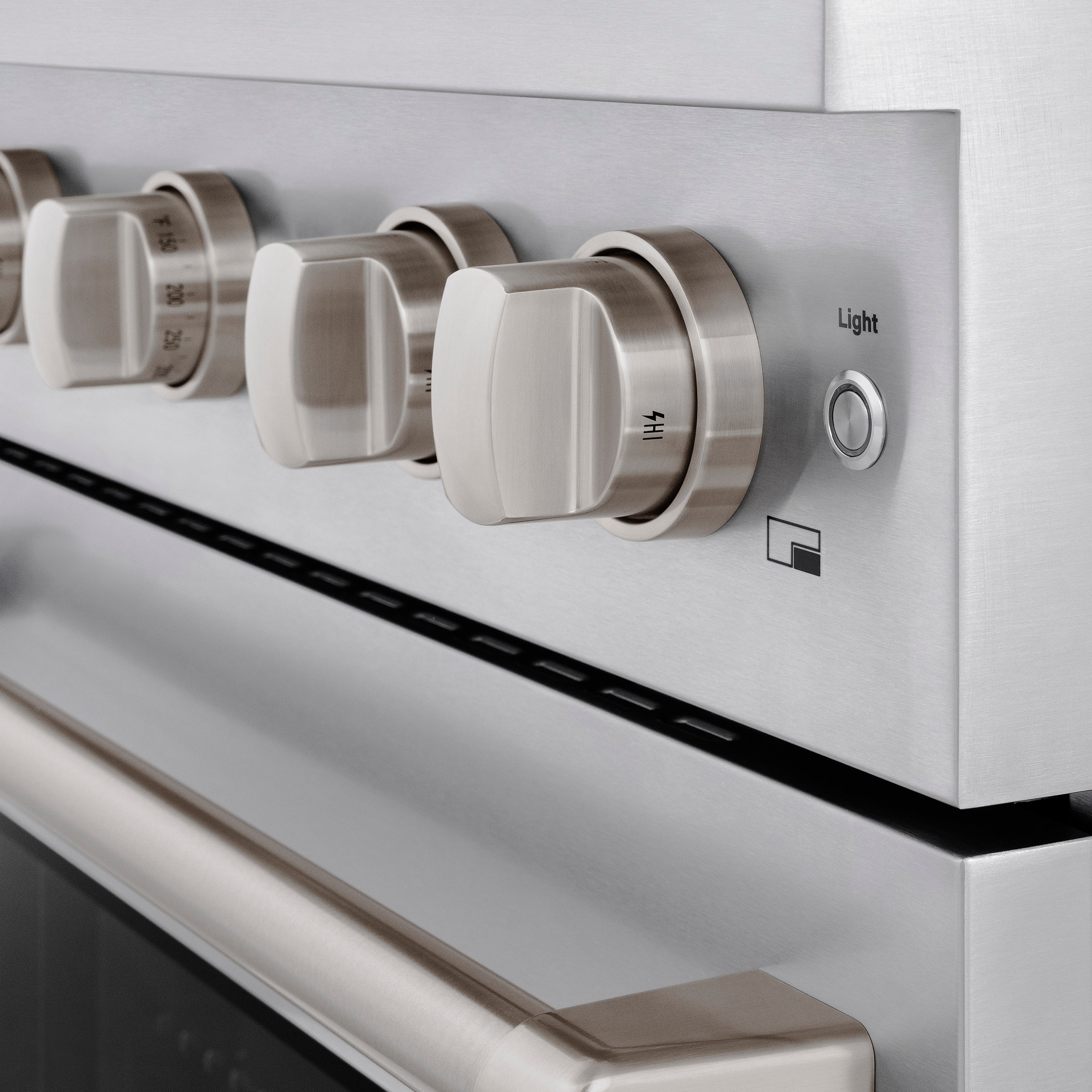 Stainless steel oven control panel with knob cluster and light indicator label