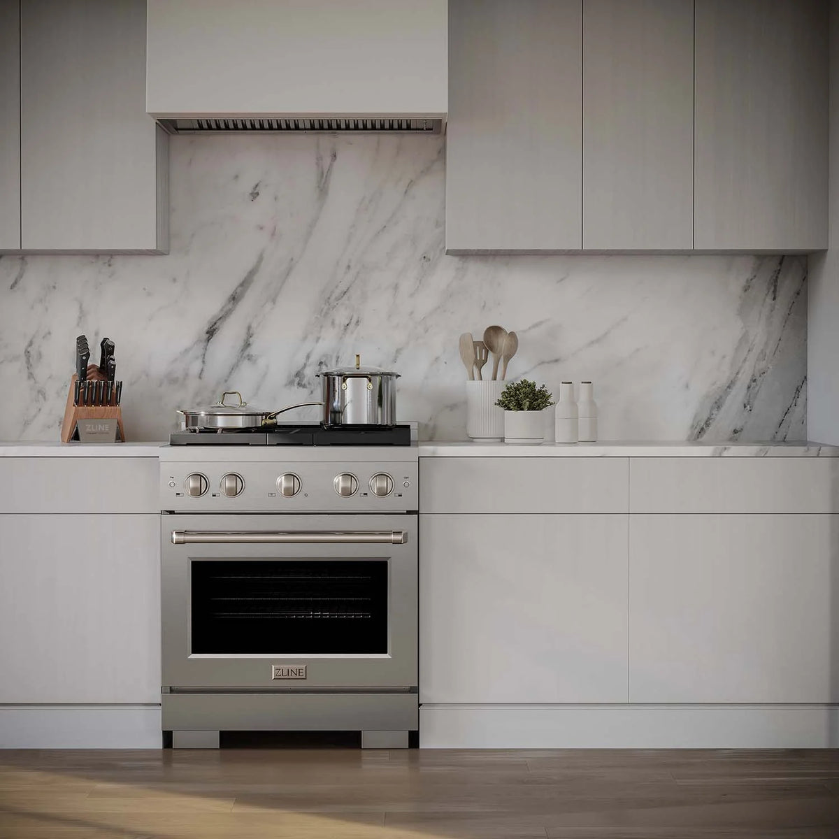 Stainless steel gas range with four burners and a convection oven door closed