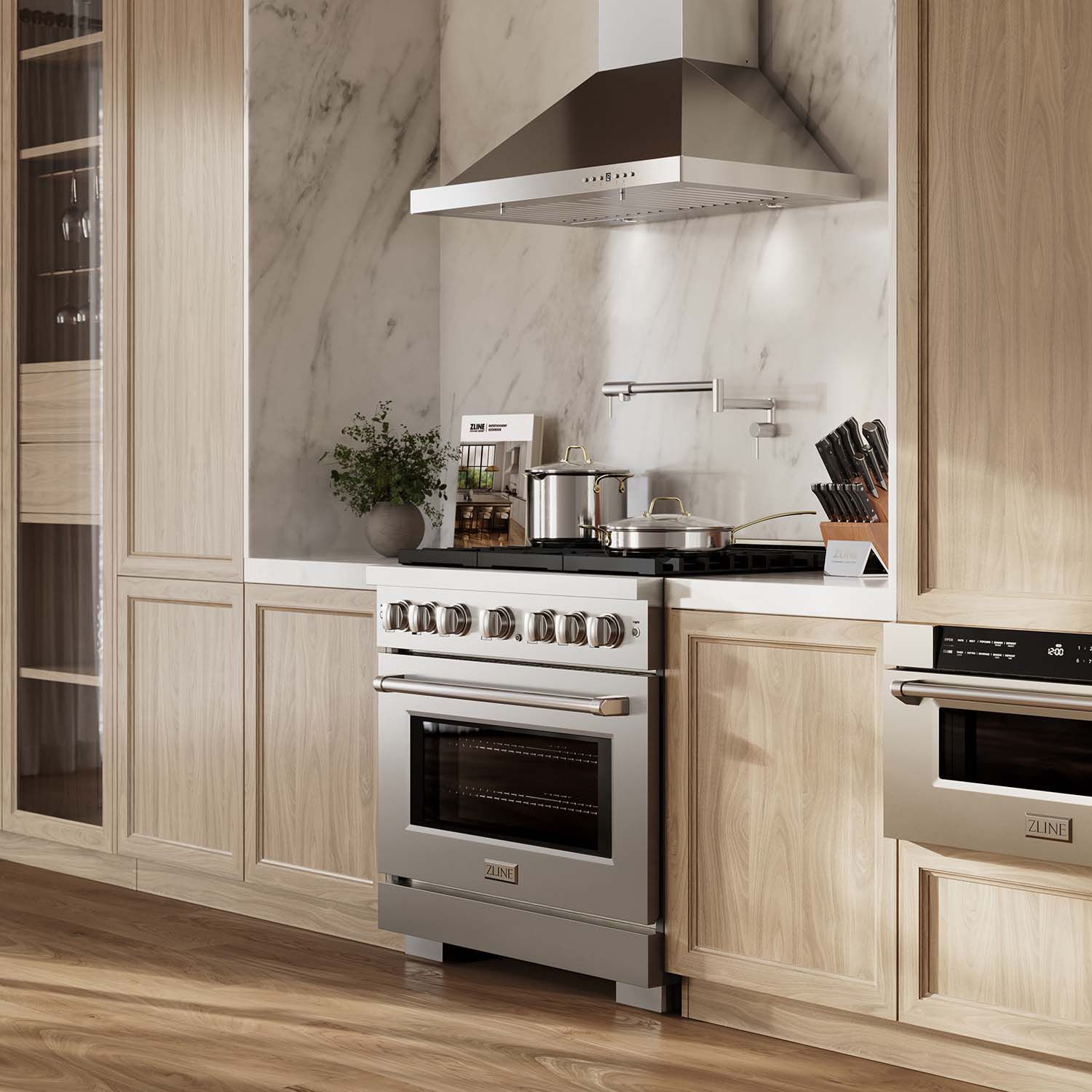Stainless steel gas range with wall-mounted range hood in a kitchen setting
