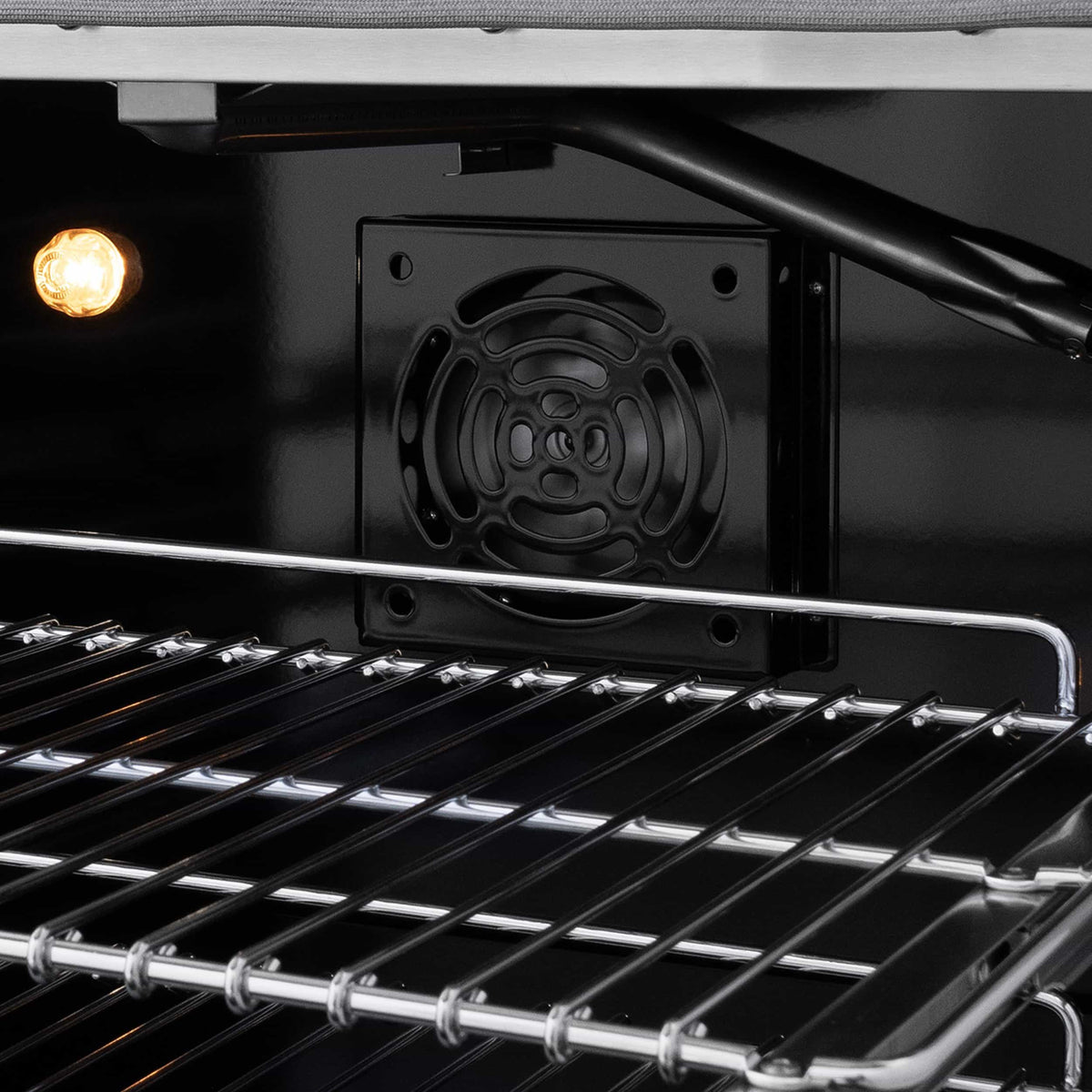 Gas oven interior with racks and circular rear burner cover