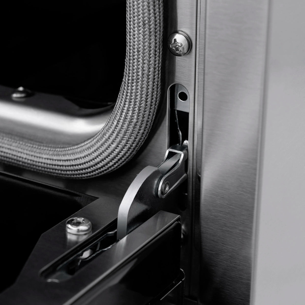 Stainless range side detail with textured cable and latch hardware
