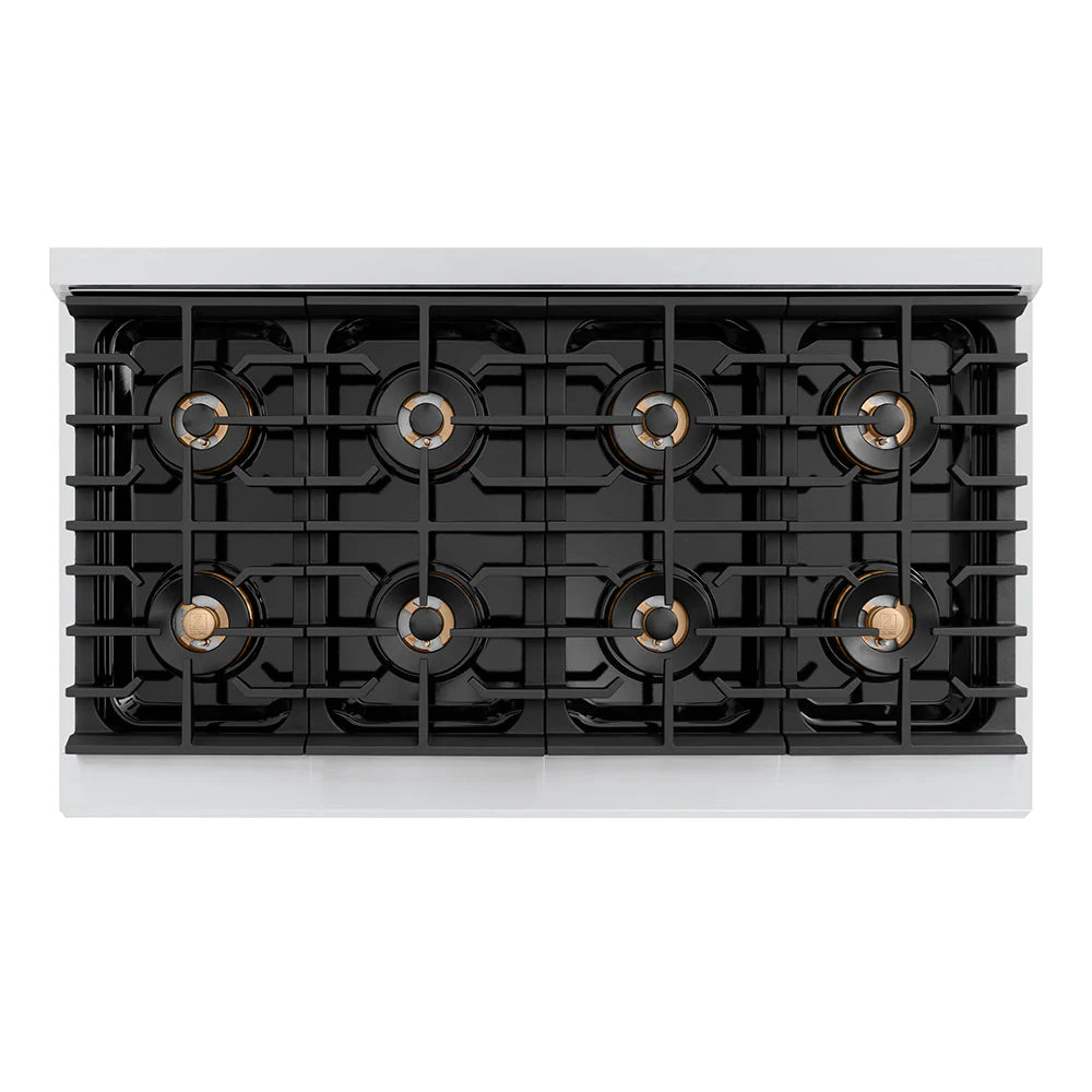 Gas cooktop burner heads with black grates and gold-toned trim.