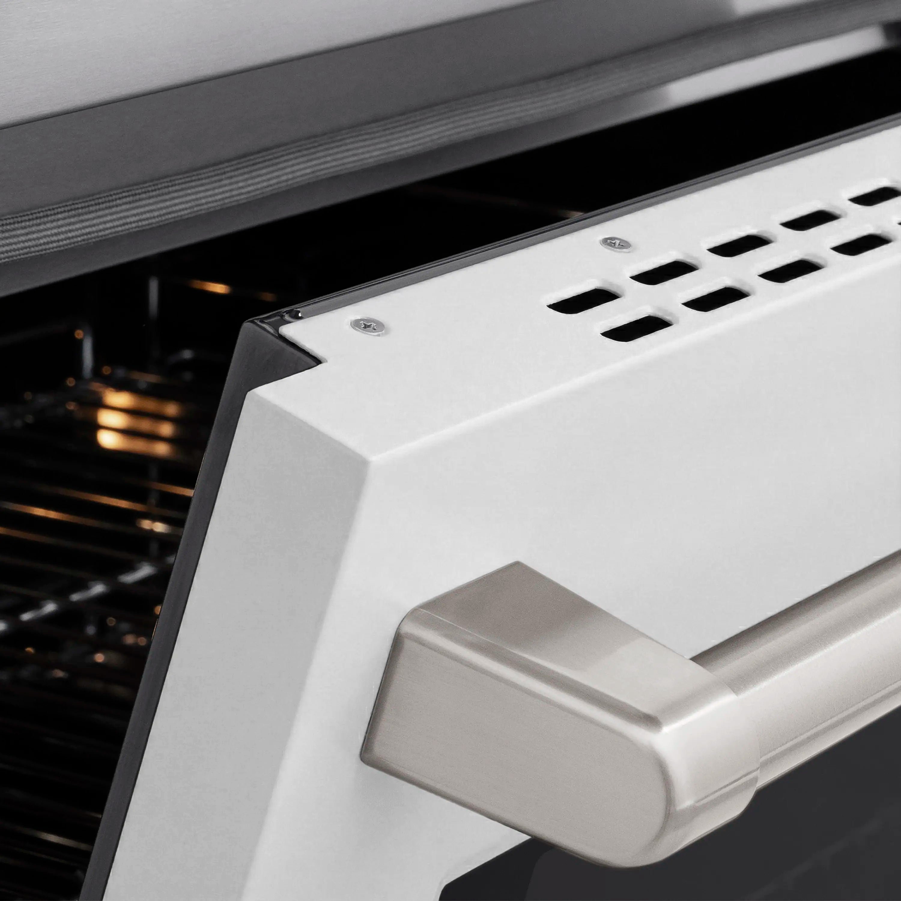 White matte oven door with stainless handle and vented panel detail