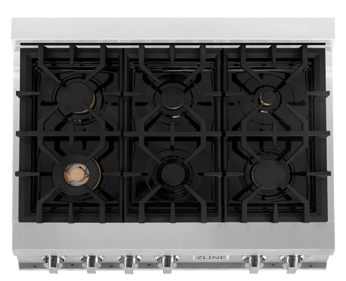 Stainless steel cooktop with six black grates and brass-colored burner caps