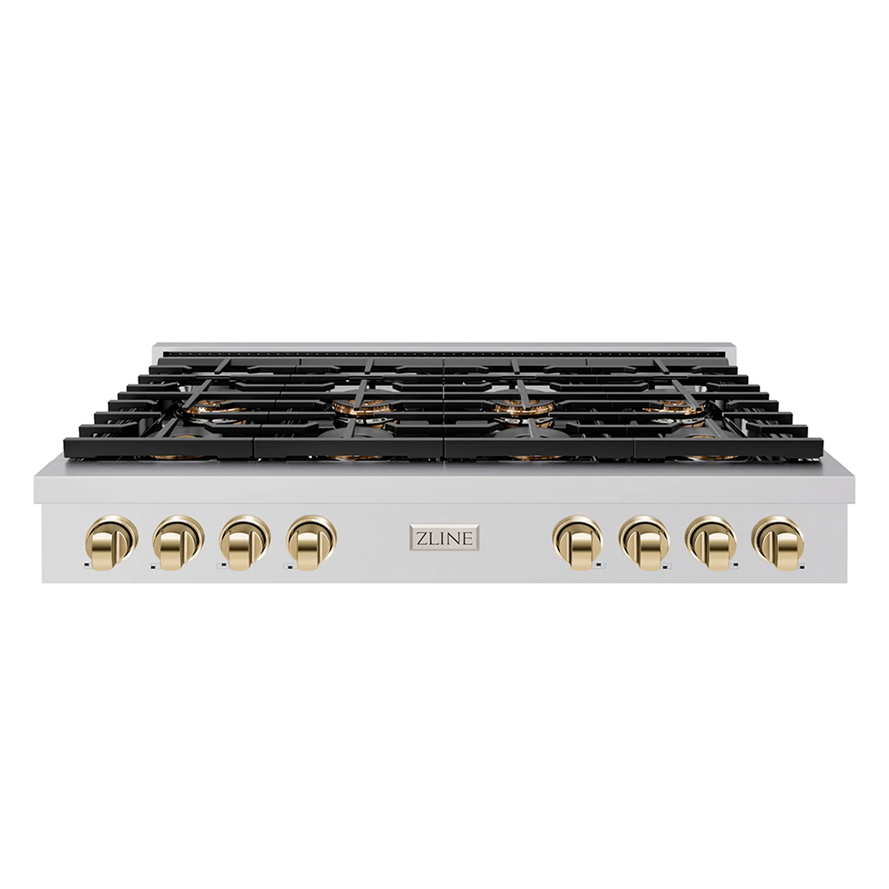 Gas cooktop with black grates and polished gold control accents