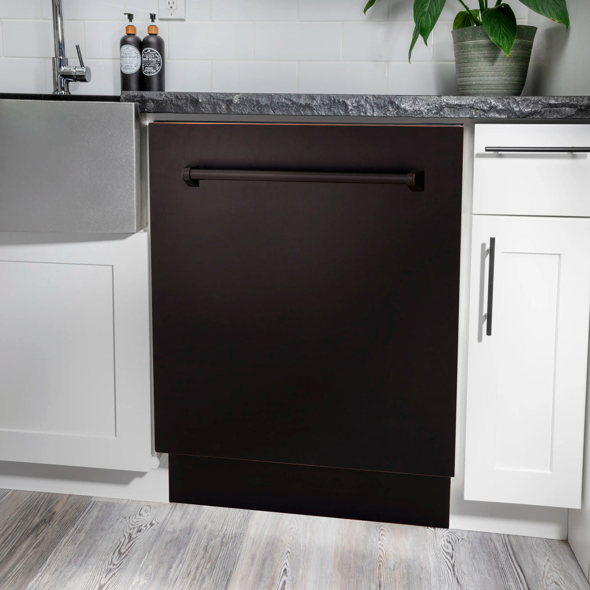 Built-in dishwasher with dark front door, recessed handle, and stainless side panels