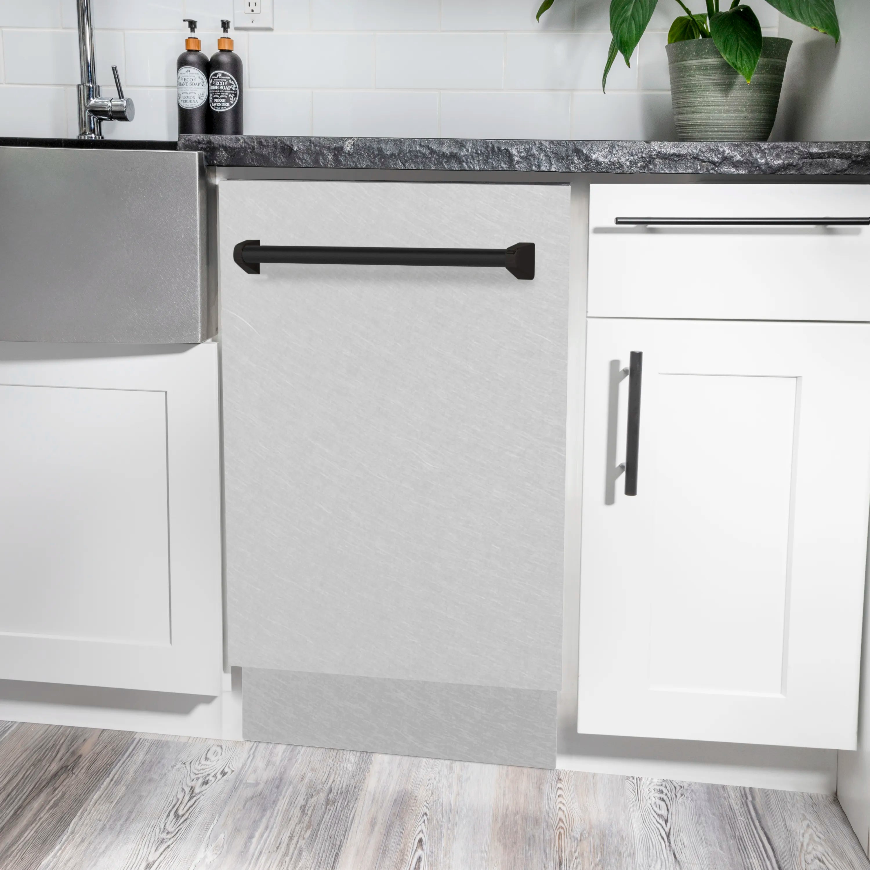 Built-in compact dishwasher with matte black handle and satin stainless steel front