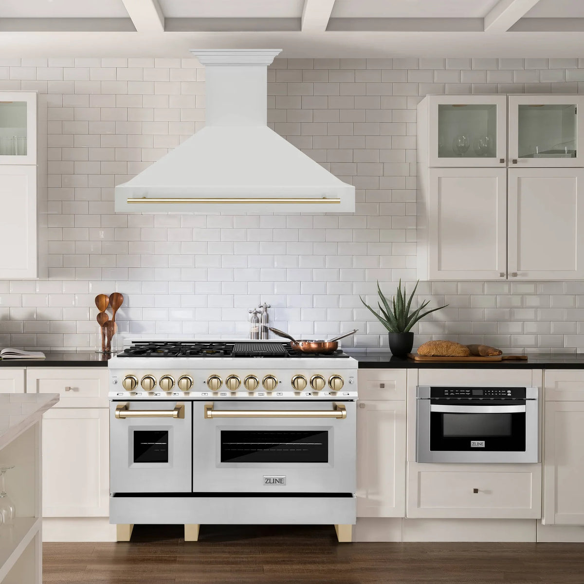 Kitchen suite featuring a white dual fuel range with gold accents and a wall hood