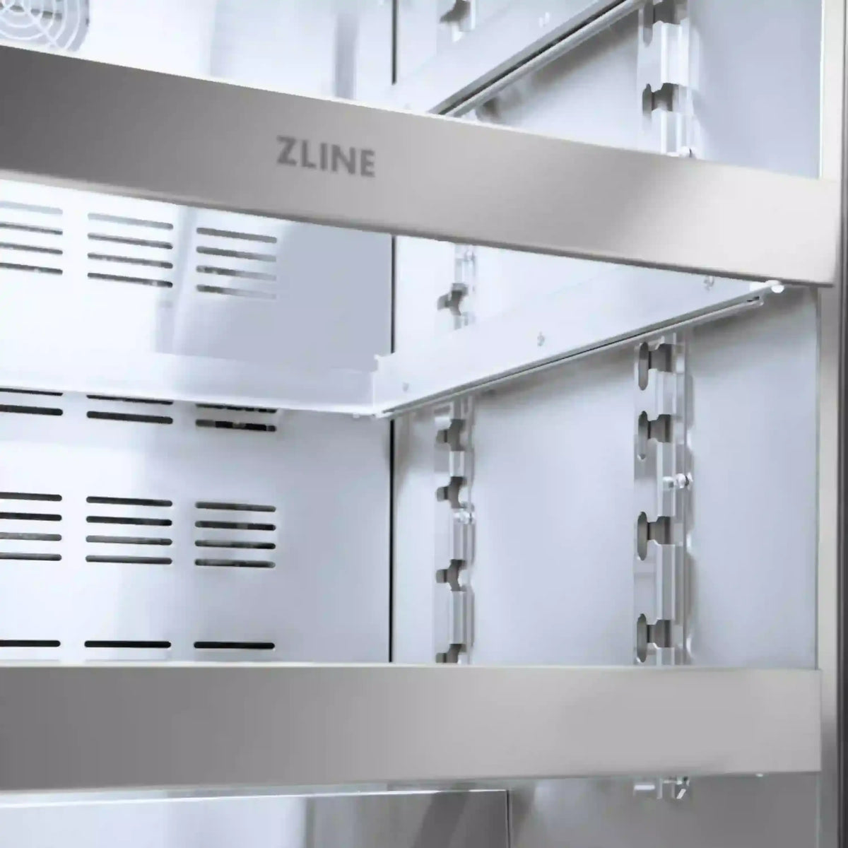 Beverage fridge interior with ZLINE logo and side-mounted shelf supports behind glass