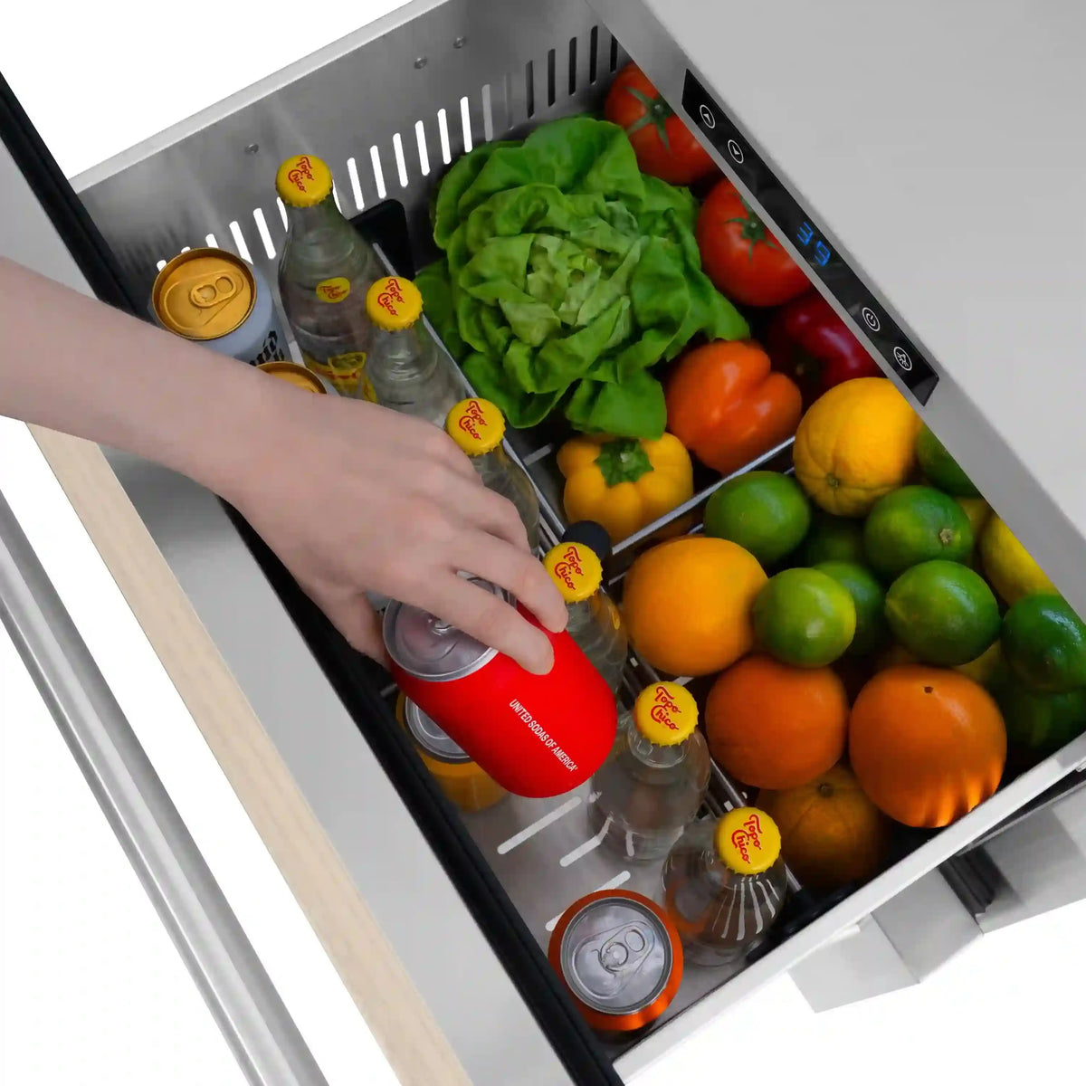 Open outdoor dual refrigerator drawer holding drinks and vegetables