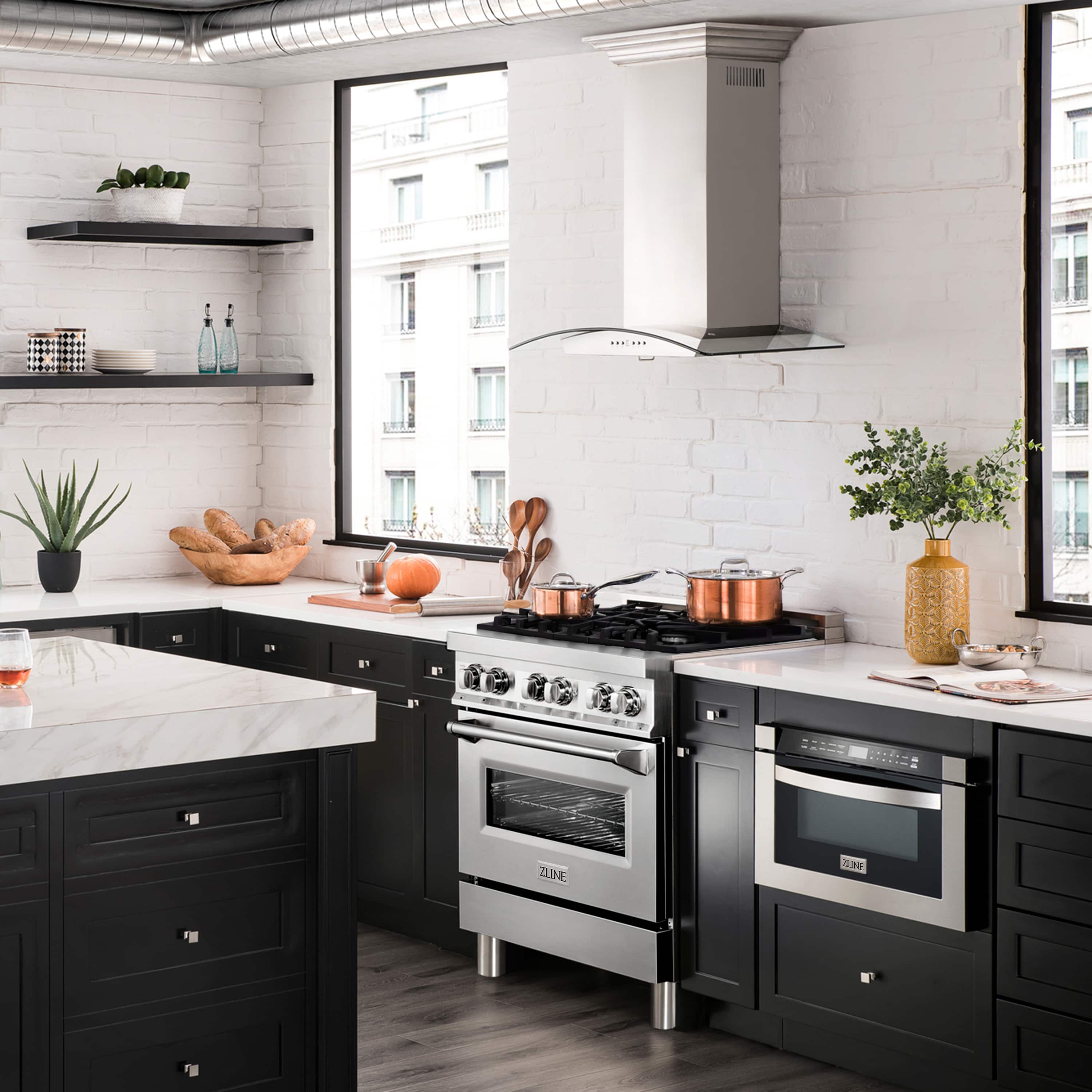 Stainless steel dual fuel range with open oven door and black cooktop grates, side angle