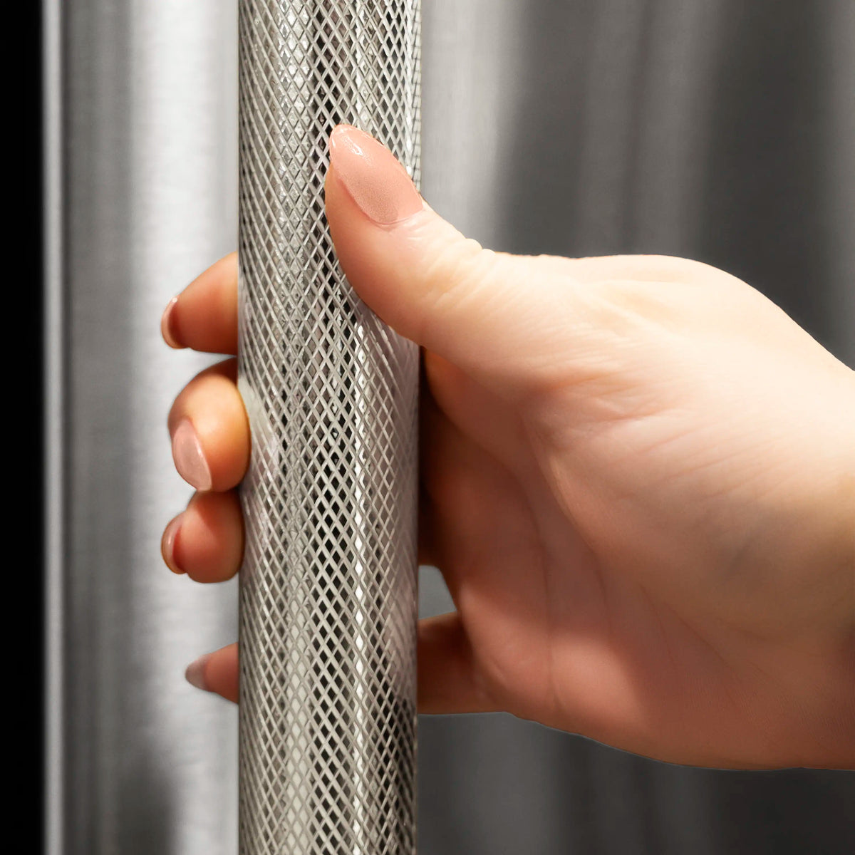 Hand opening refrigerator handle with perforated metal grip in stainless finish