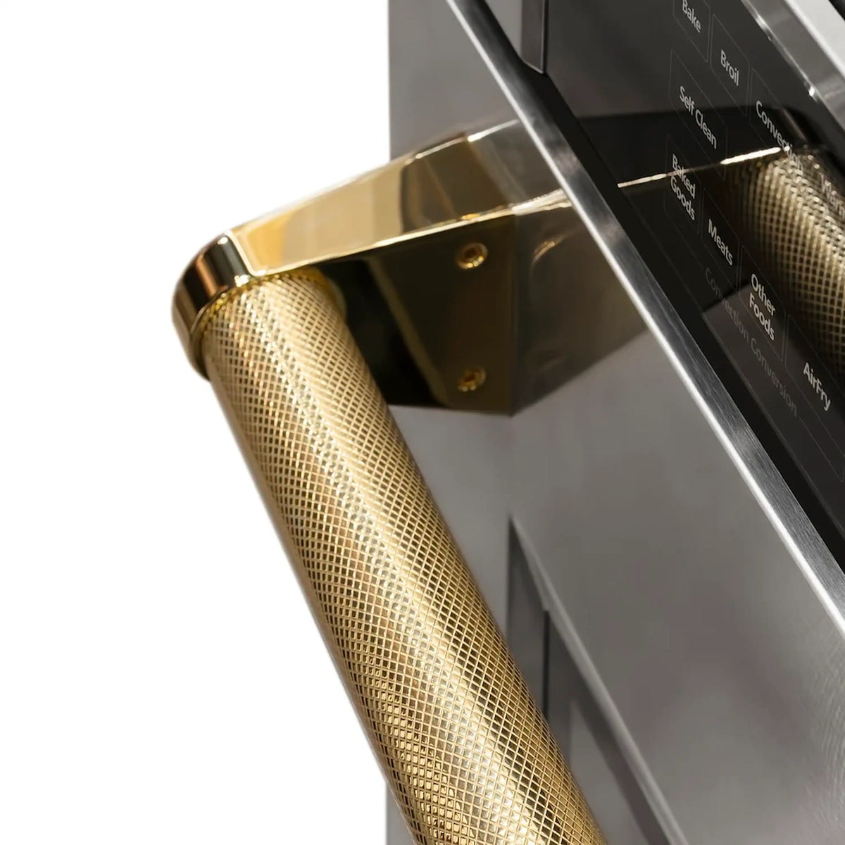 Stainless steel oven door edge with gold textured handle and control panel area