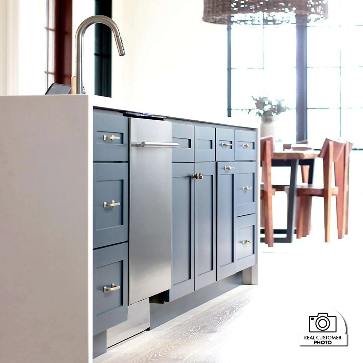 Built-in stainless steel dishwasher with modern handle installed in cabinetry
