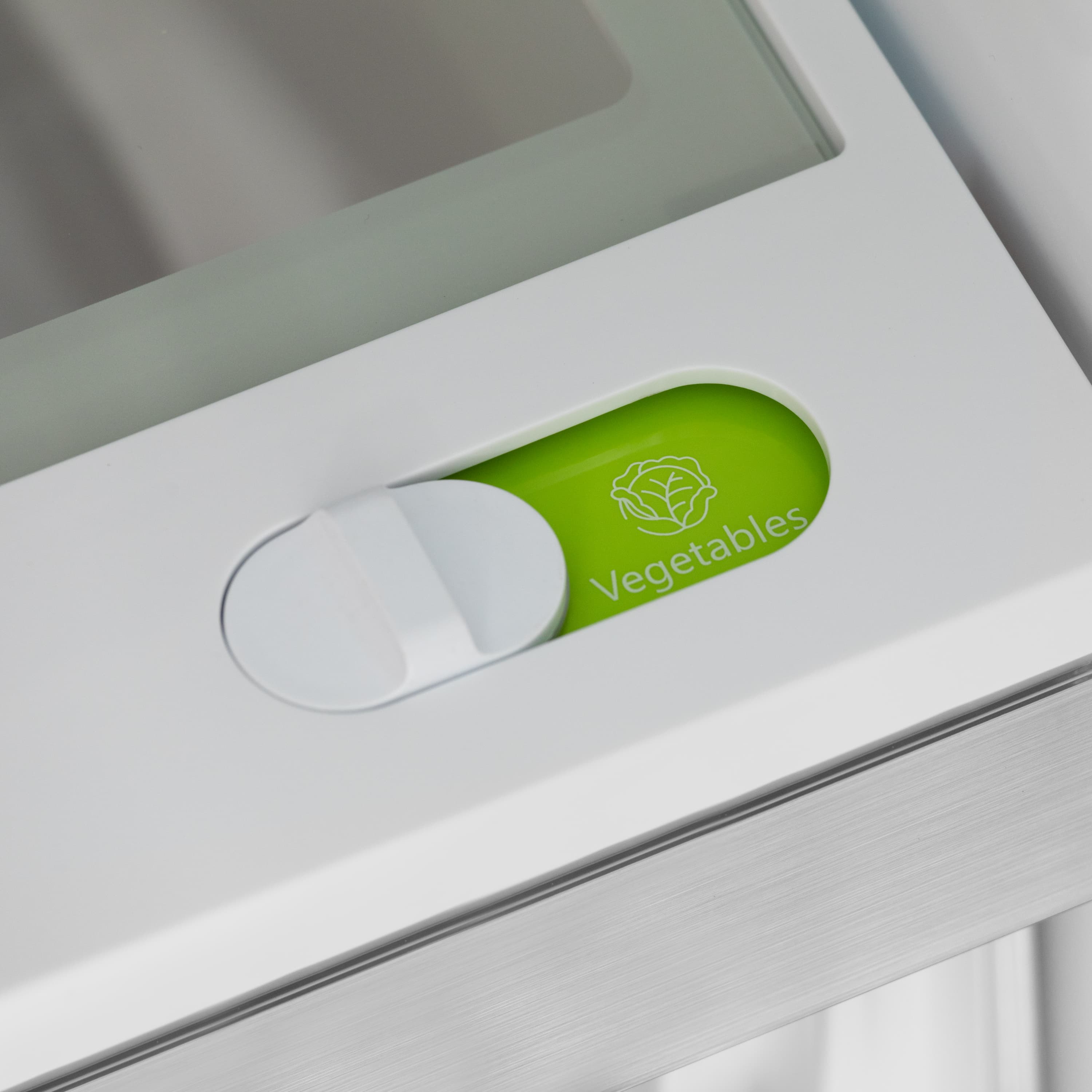 Crisper drawer with green "Vegetables" label and white pull handle