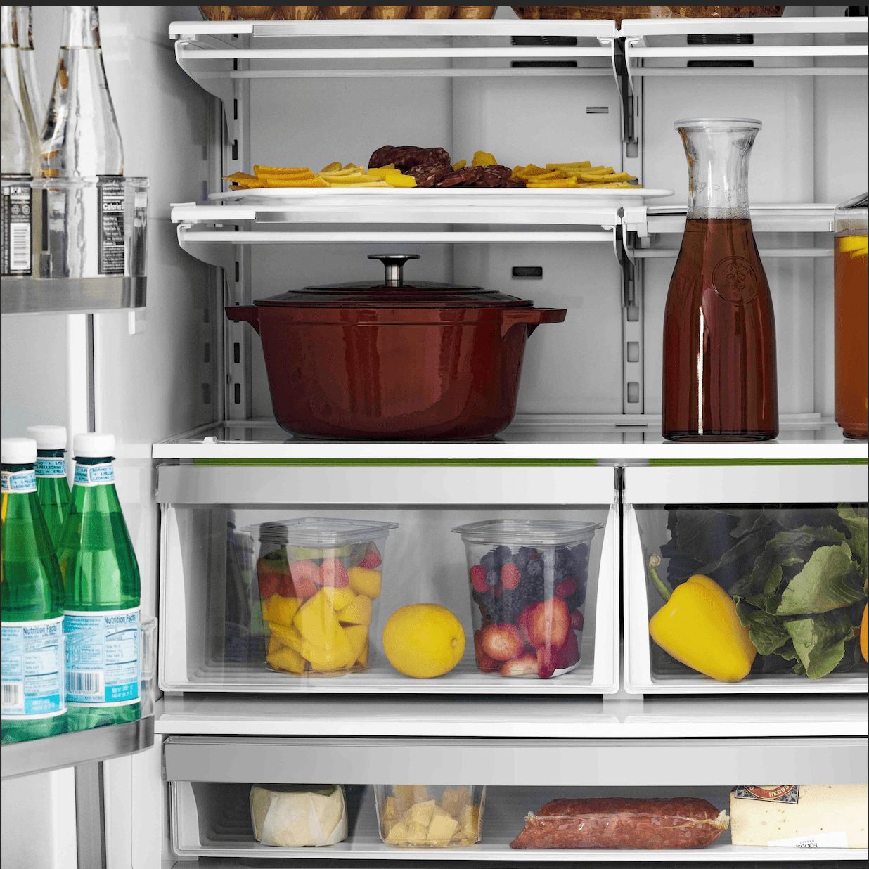 Stainless steel refrigerator lower drawers with cookware pots and food storage bins