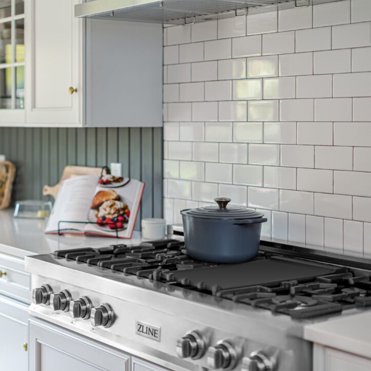 Stainless steel gas rangetop with black grates and burner controls