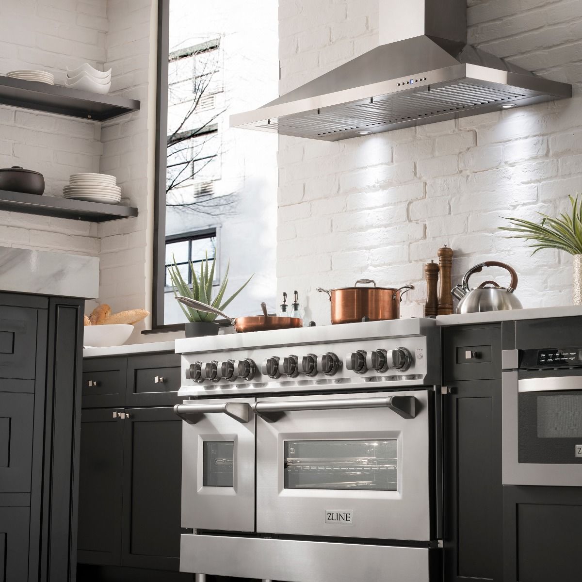 Stainless steel dual fuel range with gas burners and control knobs, oven doors below