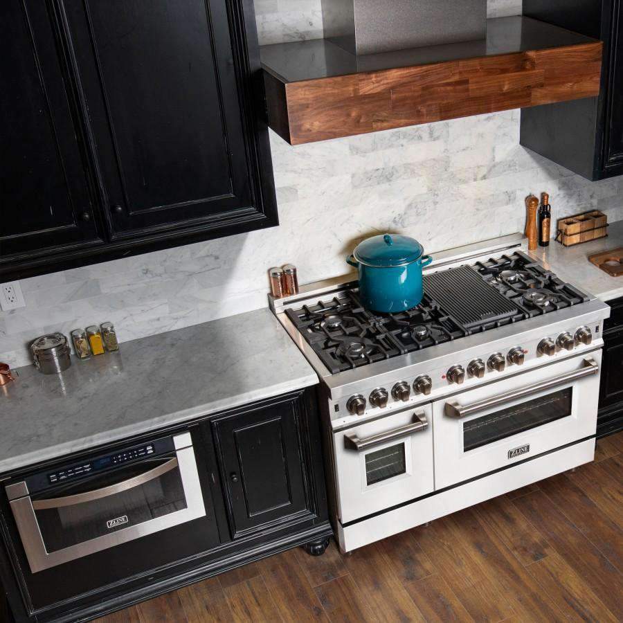 White dual-fuel range with black cooktop grates, stainless controls, and two ovens