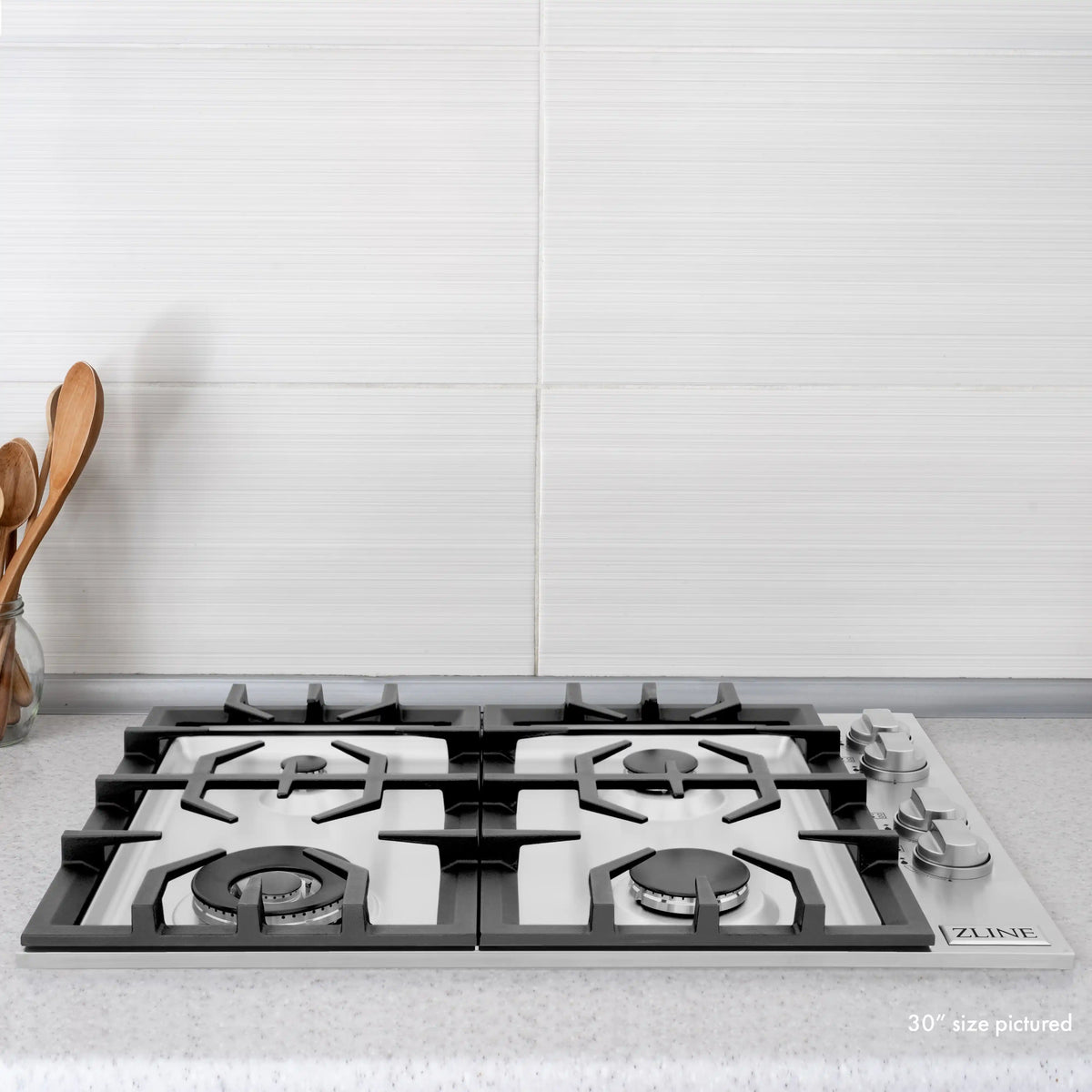 36-inch gas cooktop with four burners, black grates, and stainless frame