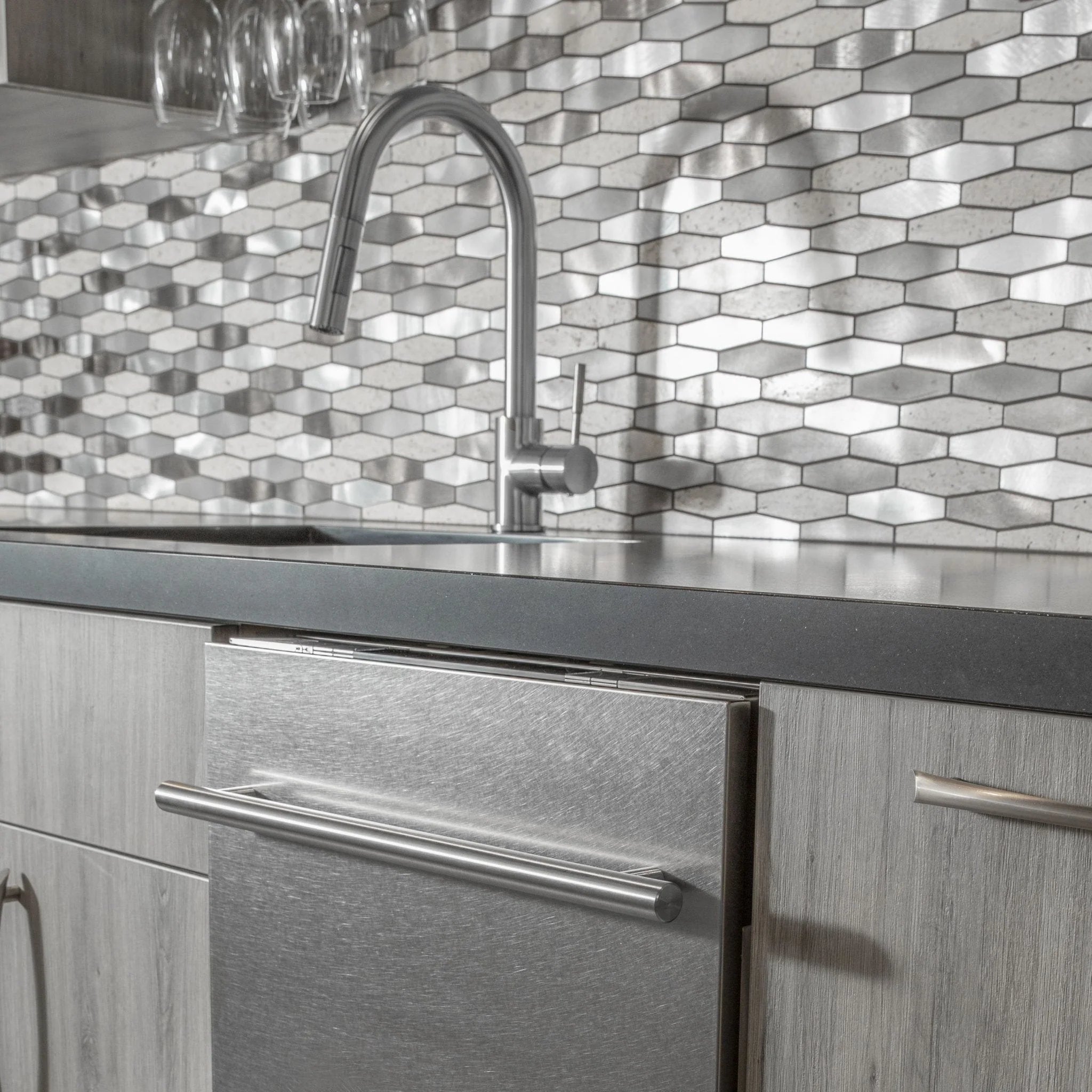 Kitchen faucet with tall arched spout and side control handle, installed on sink
