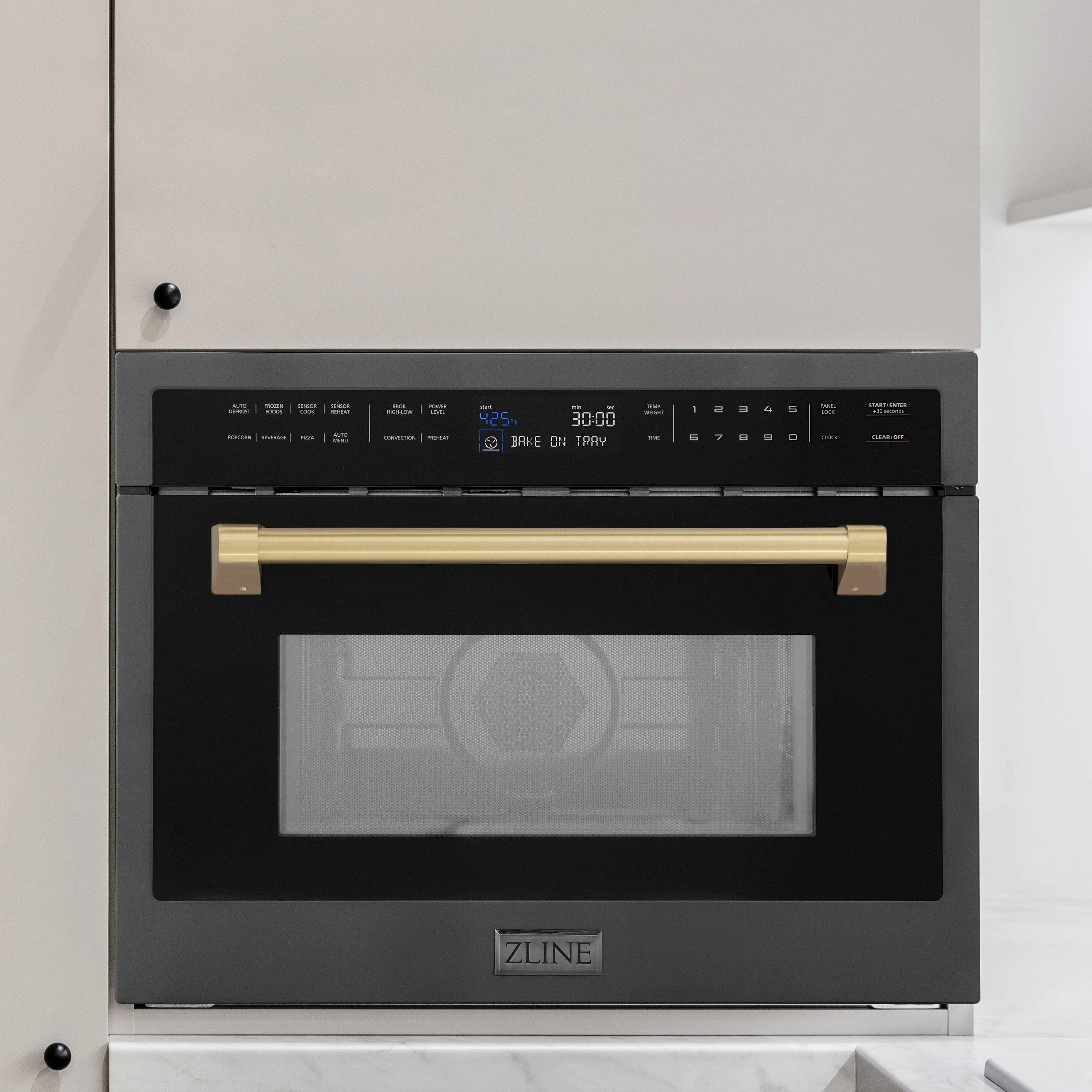 Built-in convection microwave oven, black stainless with champagne bronze handle and door window.