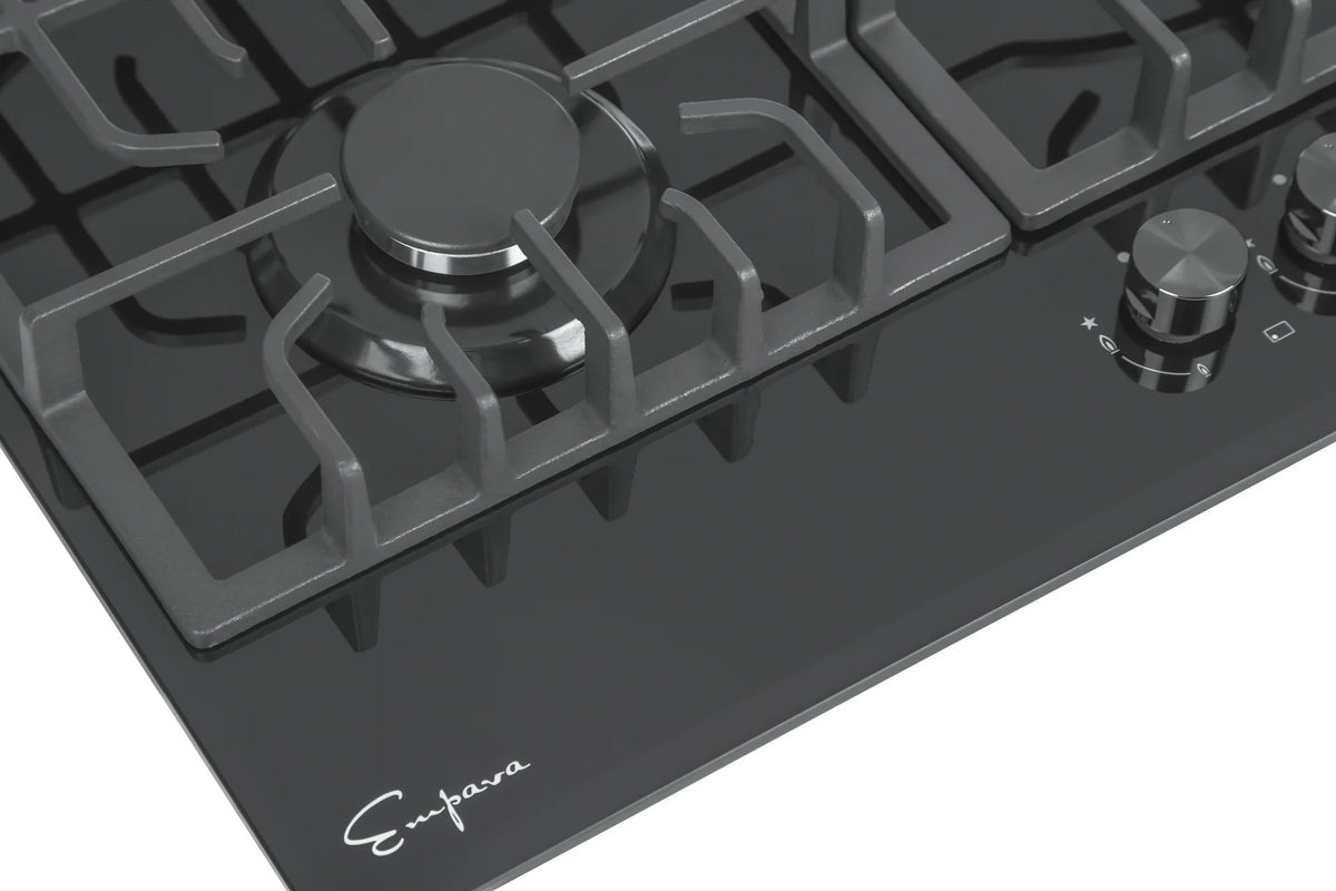Black cooktop with burner caps and control knob on a cast-iron grate