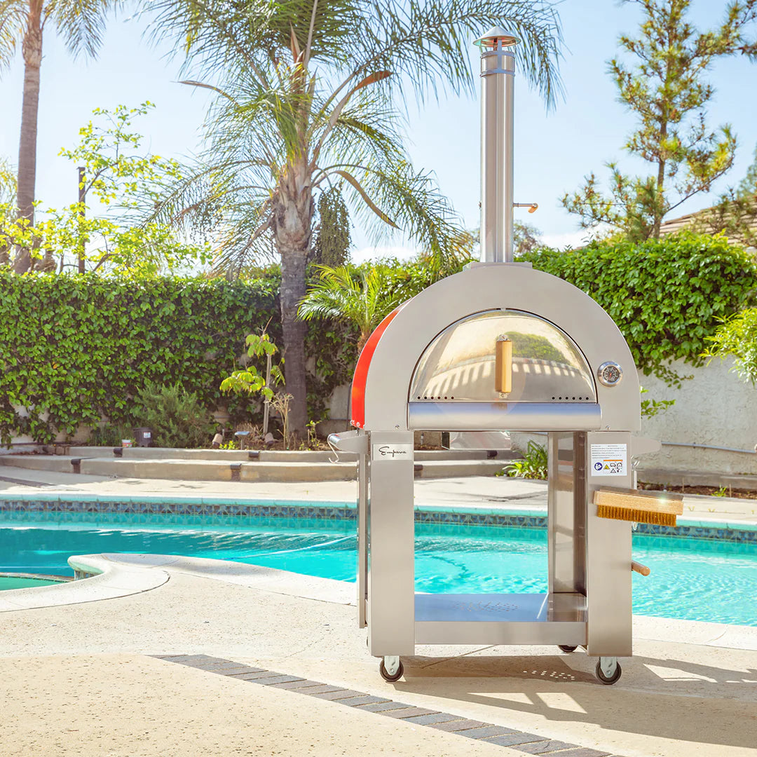 Red and white outdoor wood fired pizza oven with open arched door and chimney